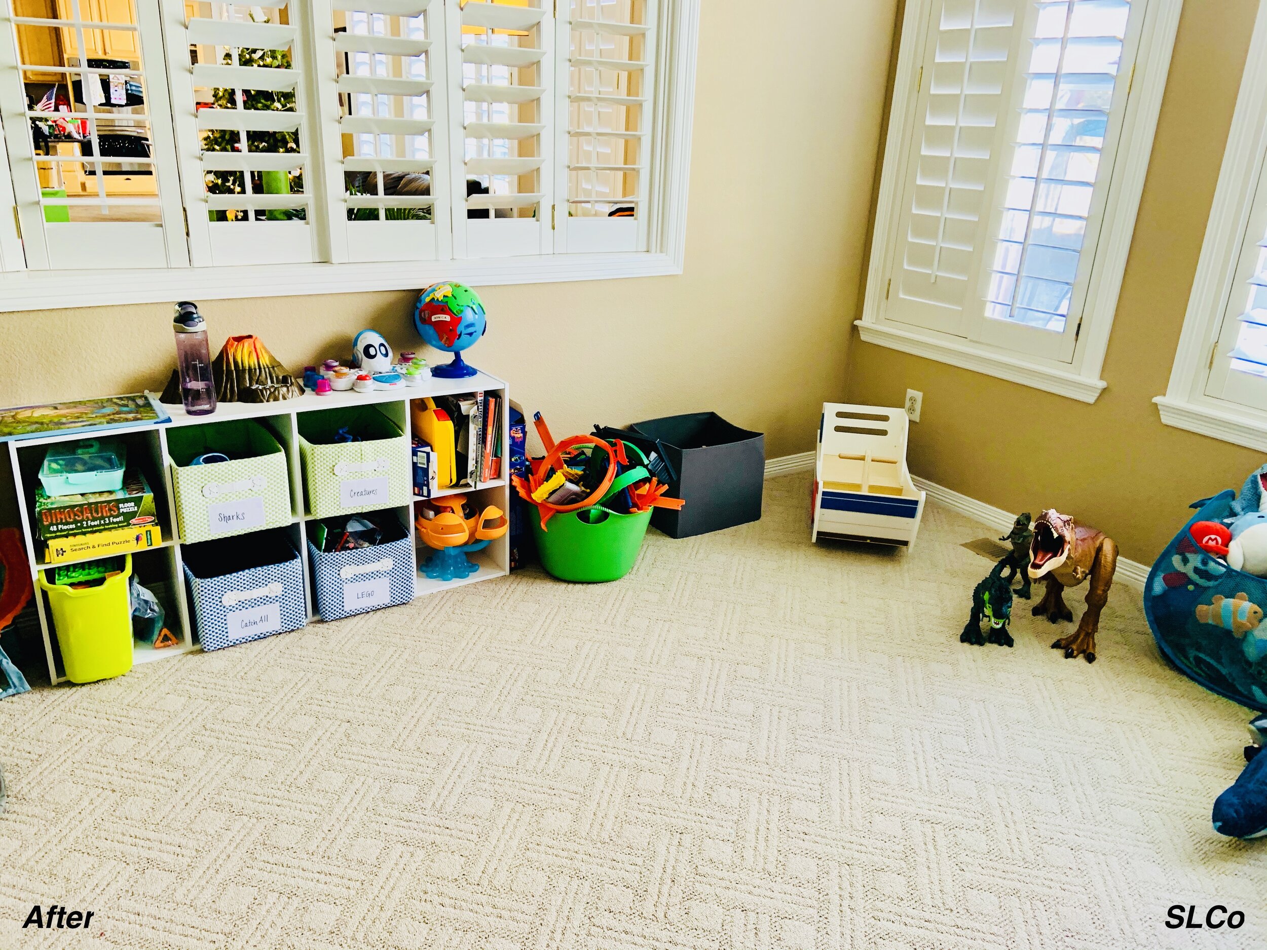After photof of playroom with cubbies with cloth bins and items organized and nothing on the floor.
