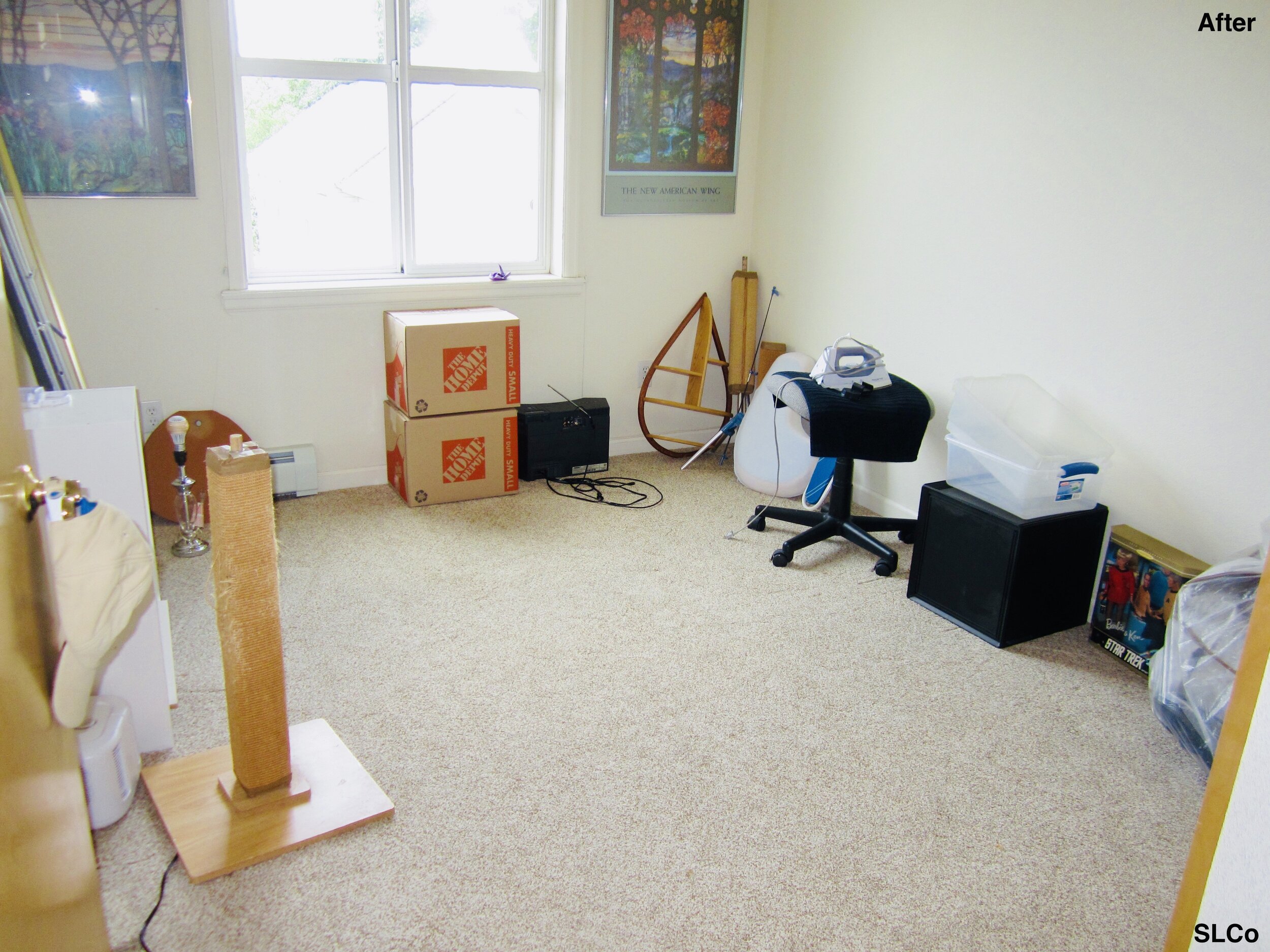 Room with white calls with  boxes unpacked, some boxes stacked along wall, and floor clear.
