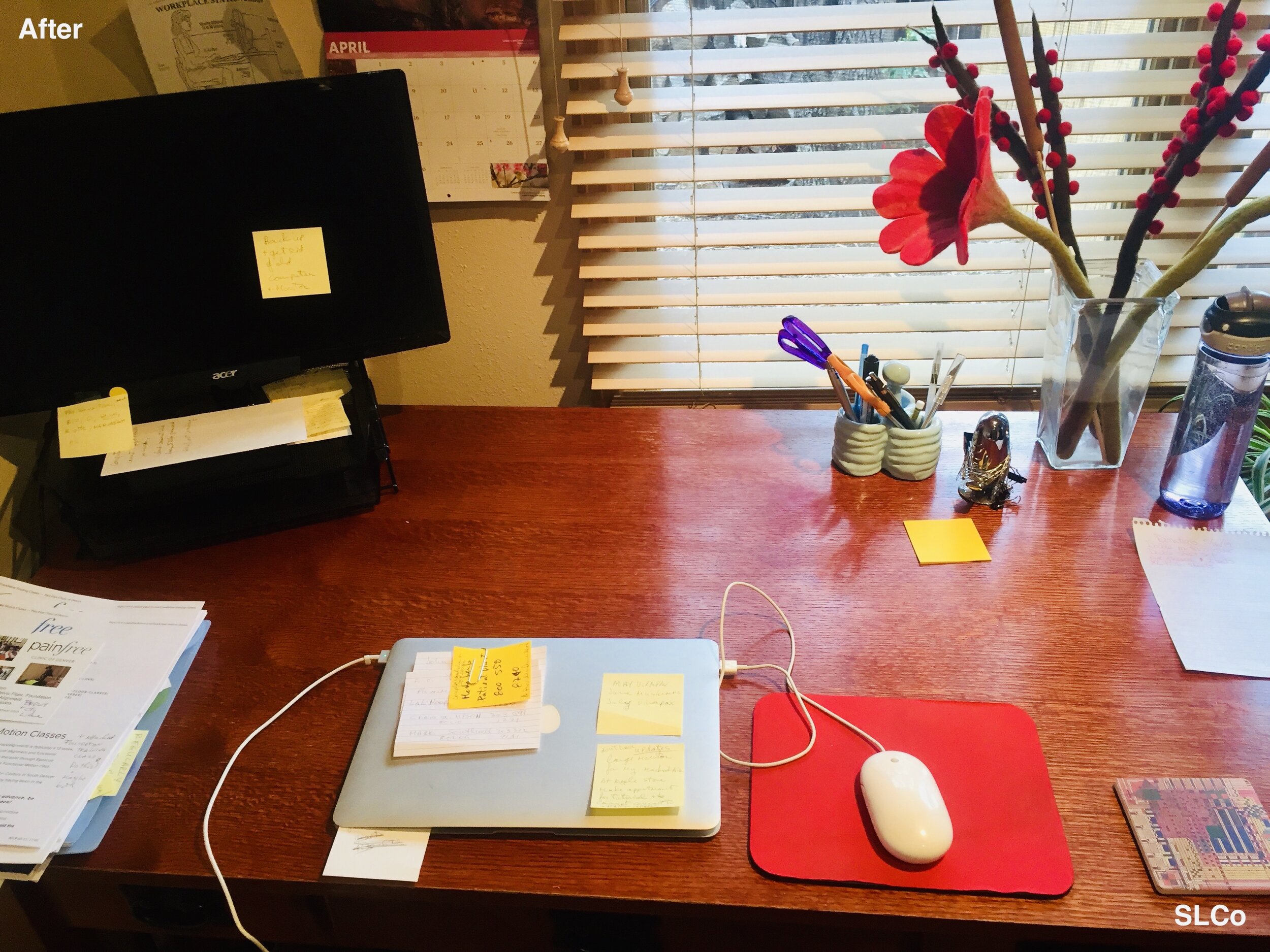 After photo of wooden desk with laptop and desktop with some postits and small stack of papers to the side.