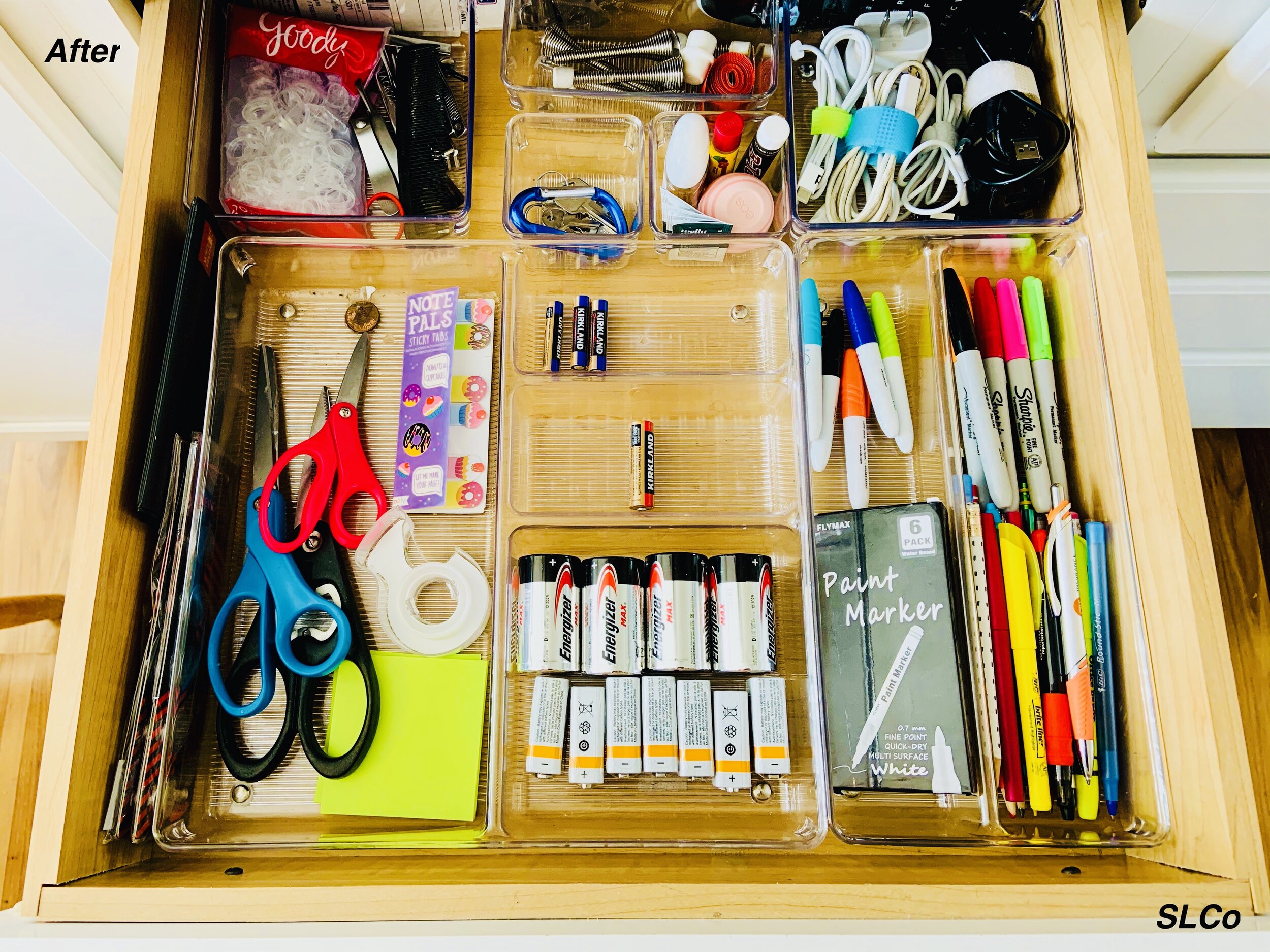 After photo of a drawer with clear organizer containers with batteries in one, pens in another, scizzors and tape, and everything having a home.