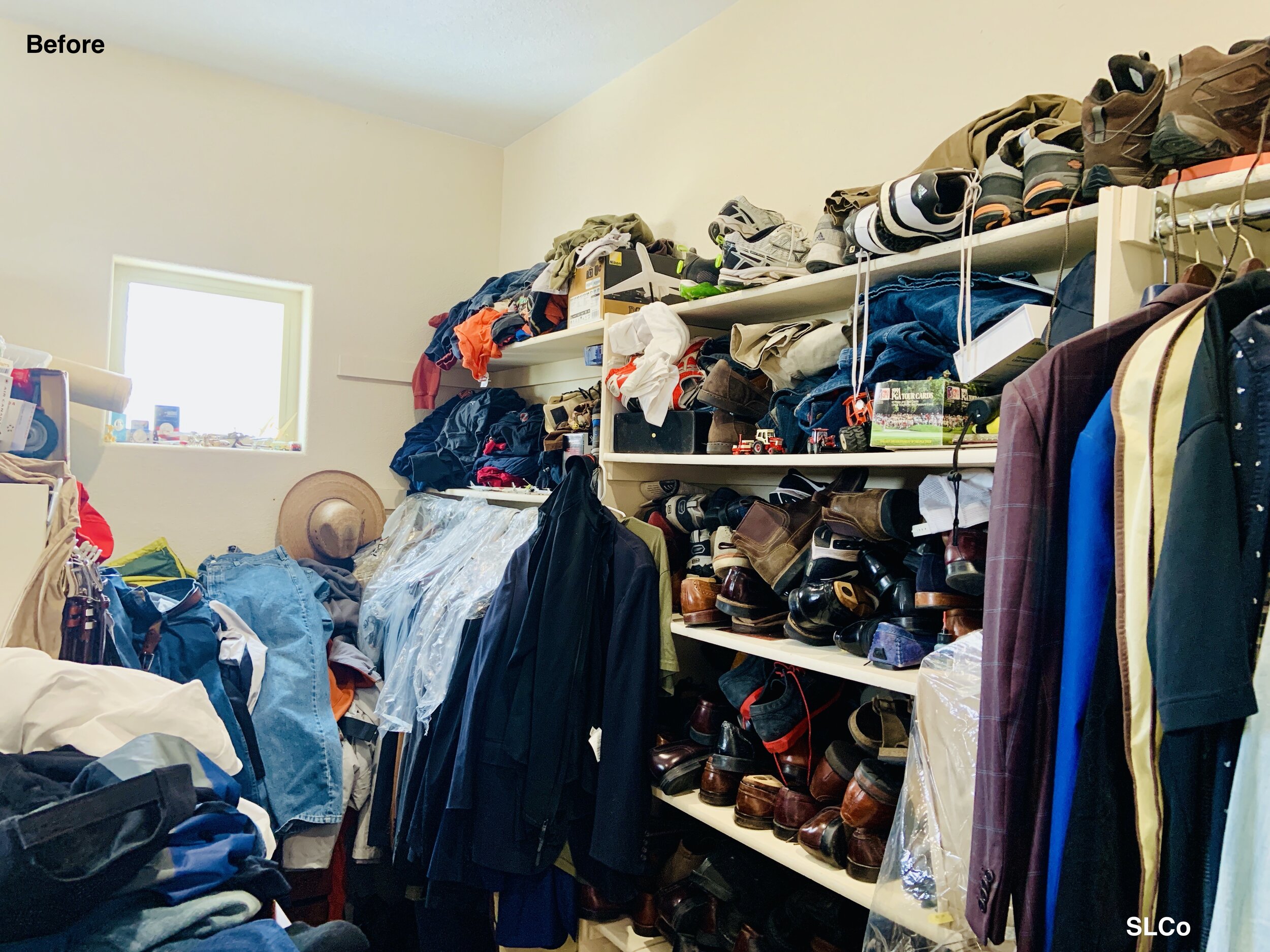 Before photo of large walk in closet overflowing with shoes stacked on one another, clothes on a hangers and some over the hanging bar, and little room to walk with stacks of clothes on the floor.