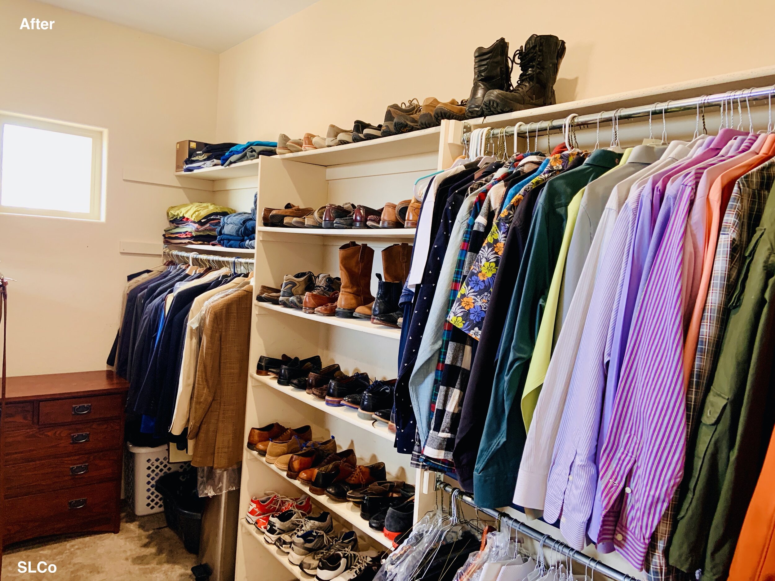 One side of a large walk in closet with no overflowing hanging clothes and shoes on shelves without being stacked on one another.