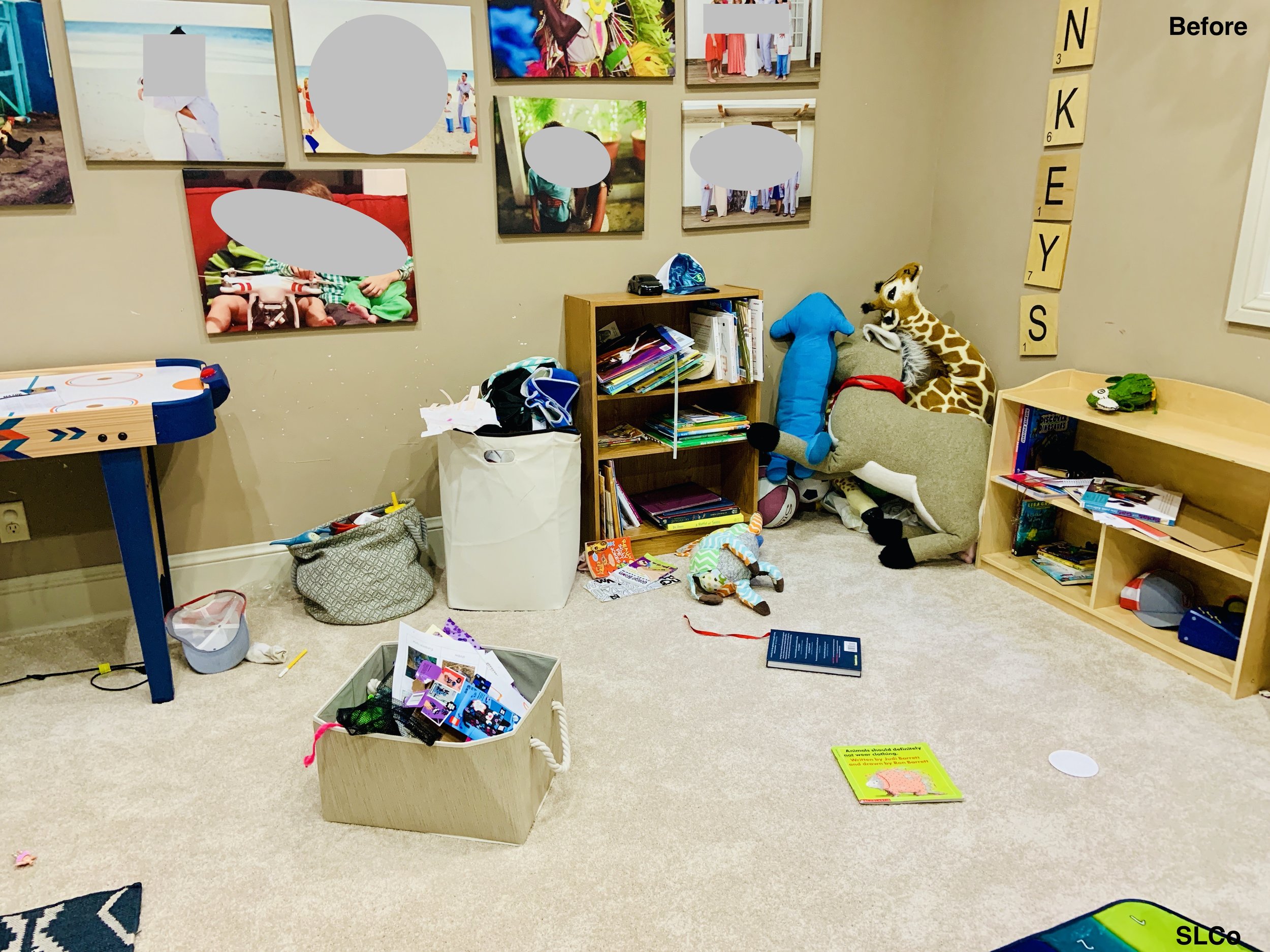 Before photo of playroom with toys on the floor and small shelf overflowing with toys, artwork on the walls.