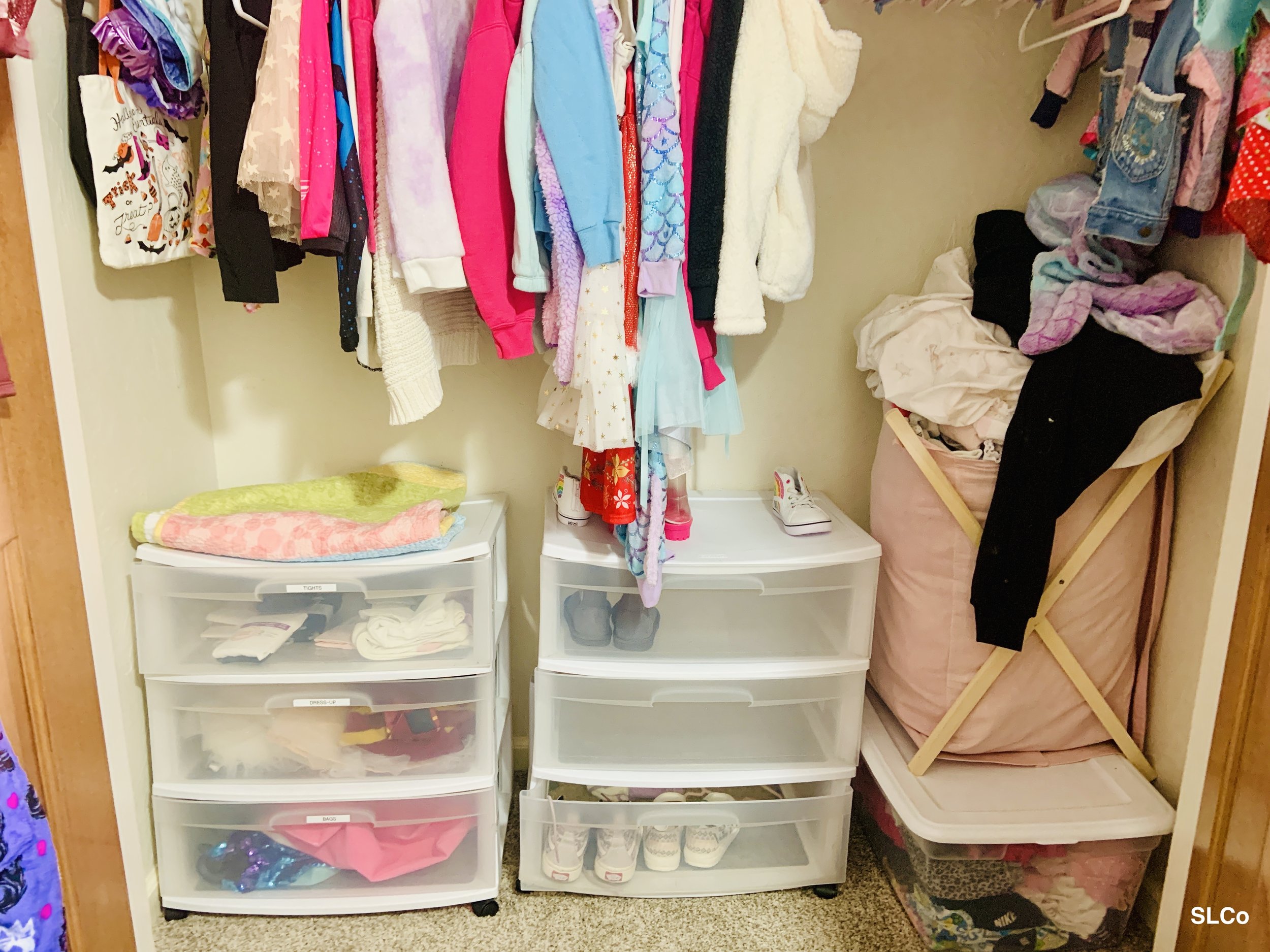 After image of little girls closet with white and clear three stack drawers with organized shoes and clothes folded and clothes hanging above organized and stack of clothes from floor in a hamper.