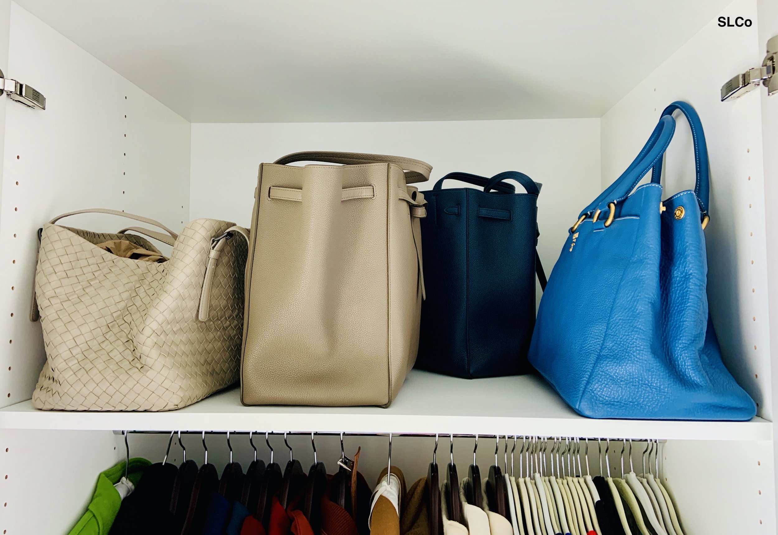 Blue and beige purses organized on a shelf