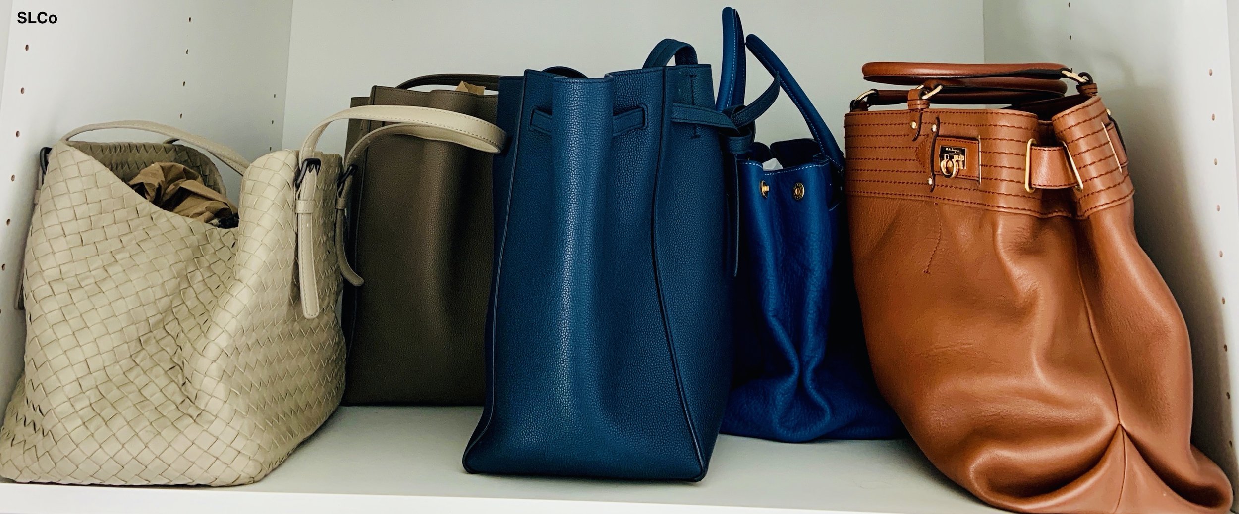 Close up image of blue and beige purses on a shelf.