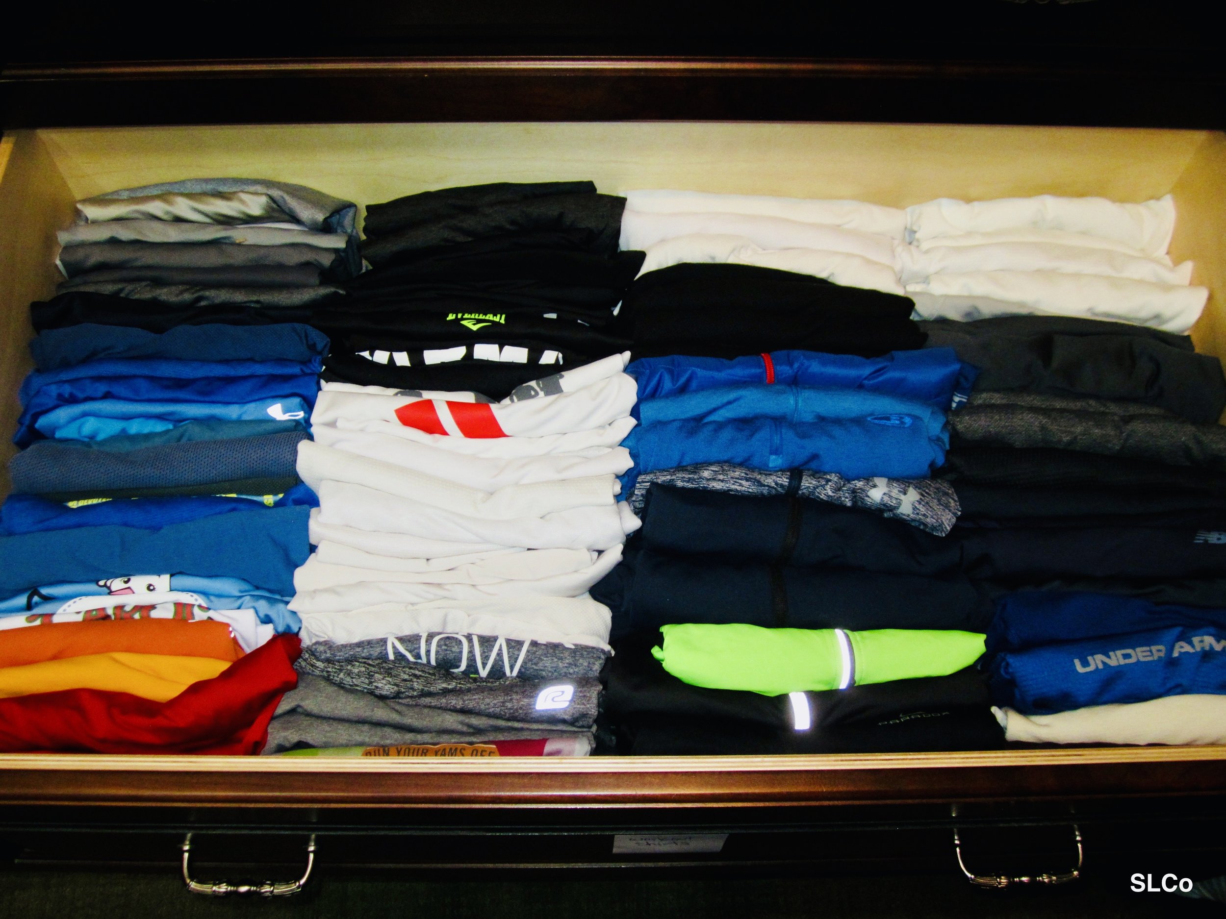 Shelf filled with nicely organized and folded t-shirts