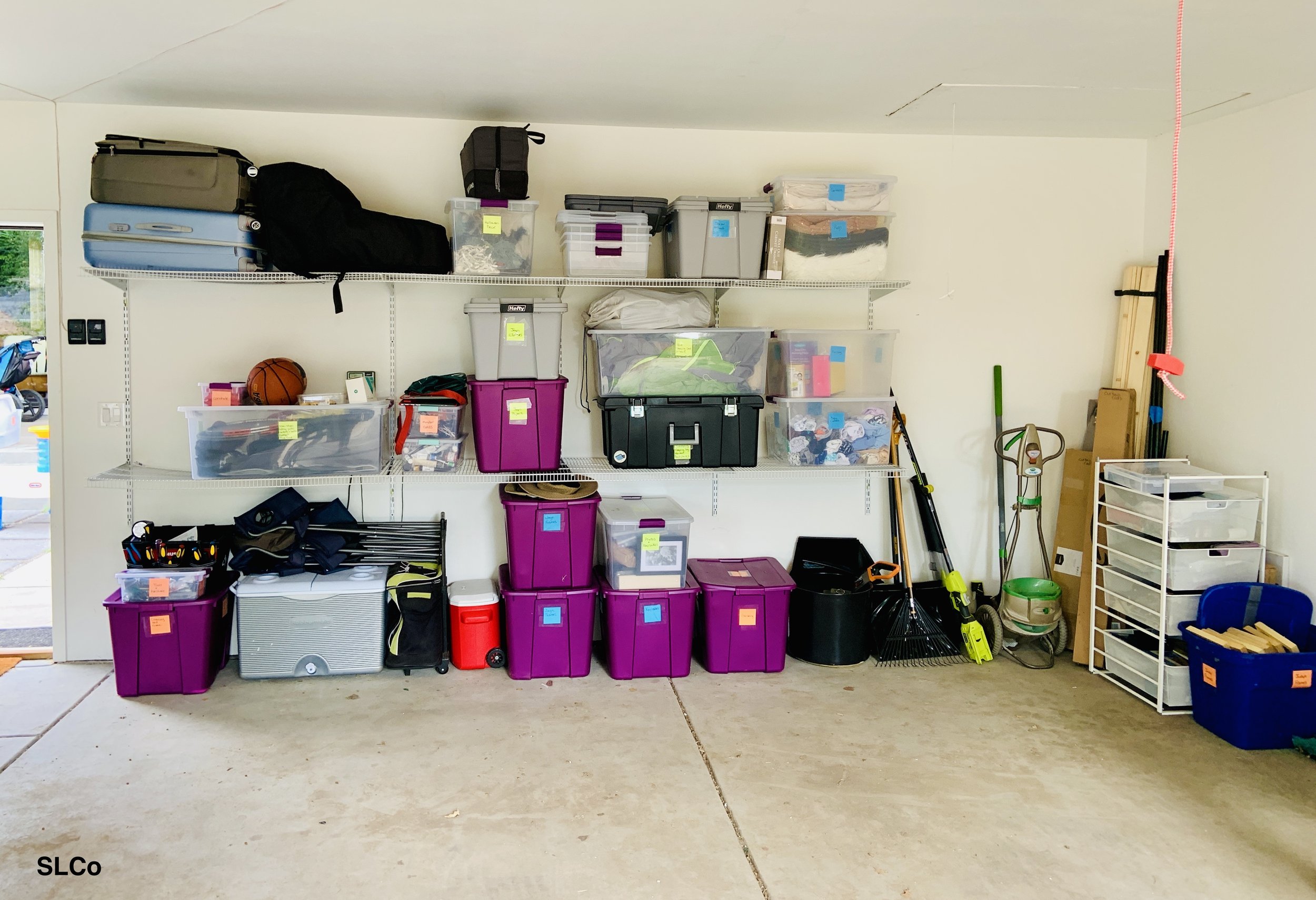 After photo of garage with containers for all items, labeled and on shelves.