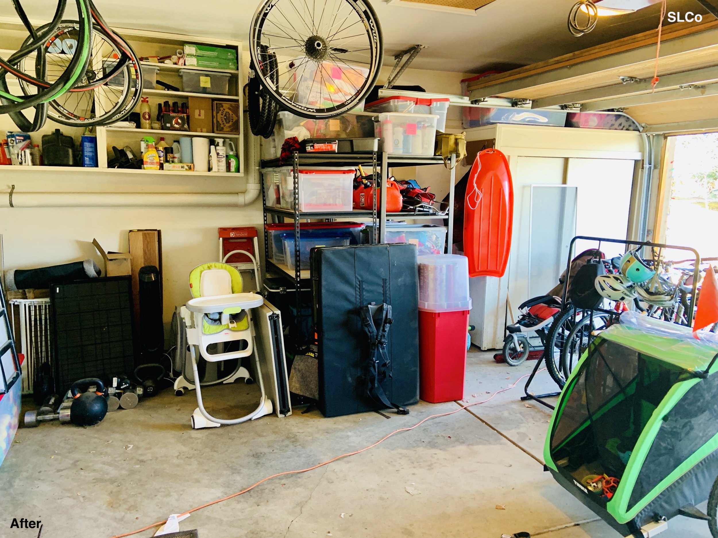 After photo of garage with items nearly placed along walls and on metal shelving units, bikes and strollers to the side