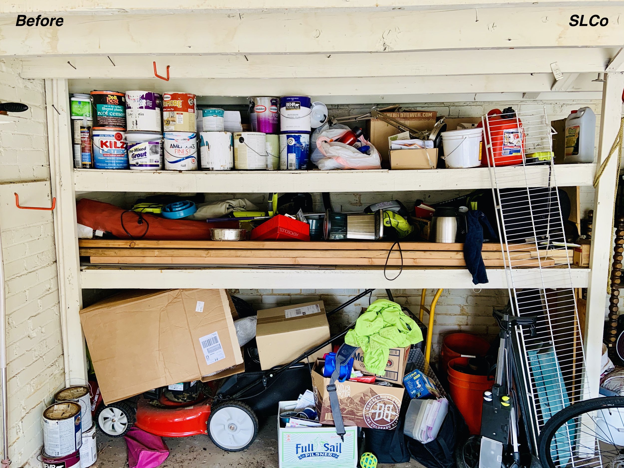 Close up before photo of garage with built in long shelves filled with paint cans, wood, and bottom with stacked random items