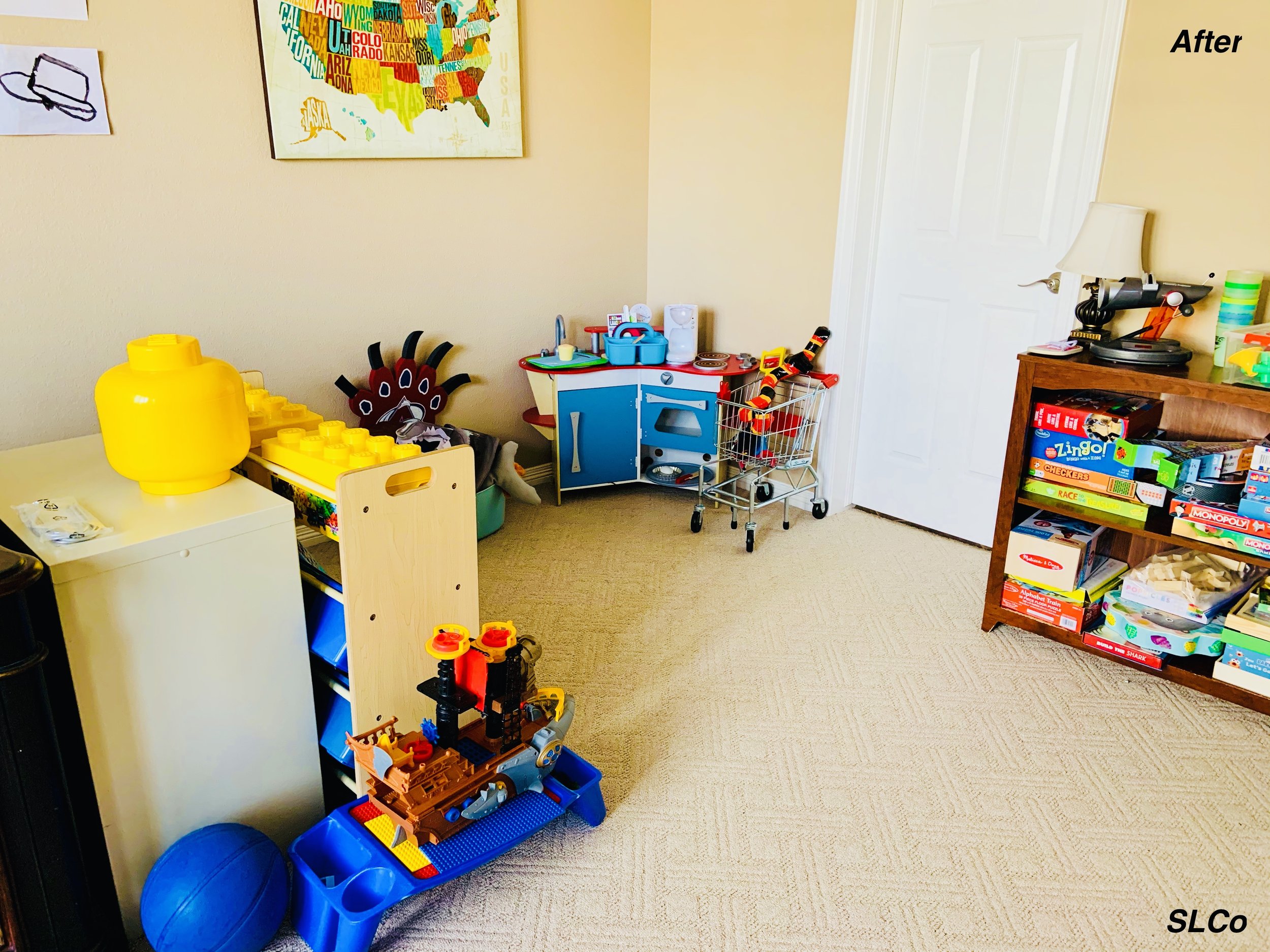 After photo of playroom with two small shelving units with items neatly organized and limited items on the floor.