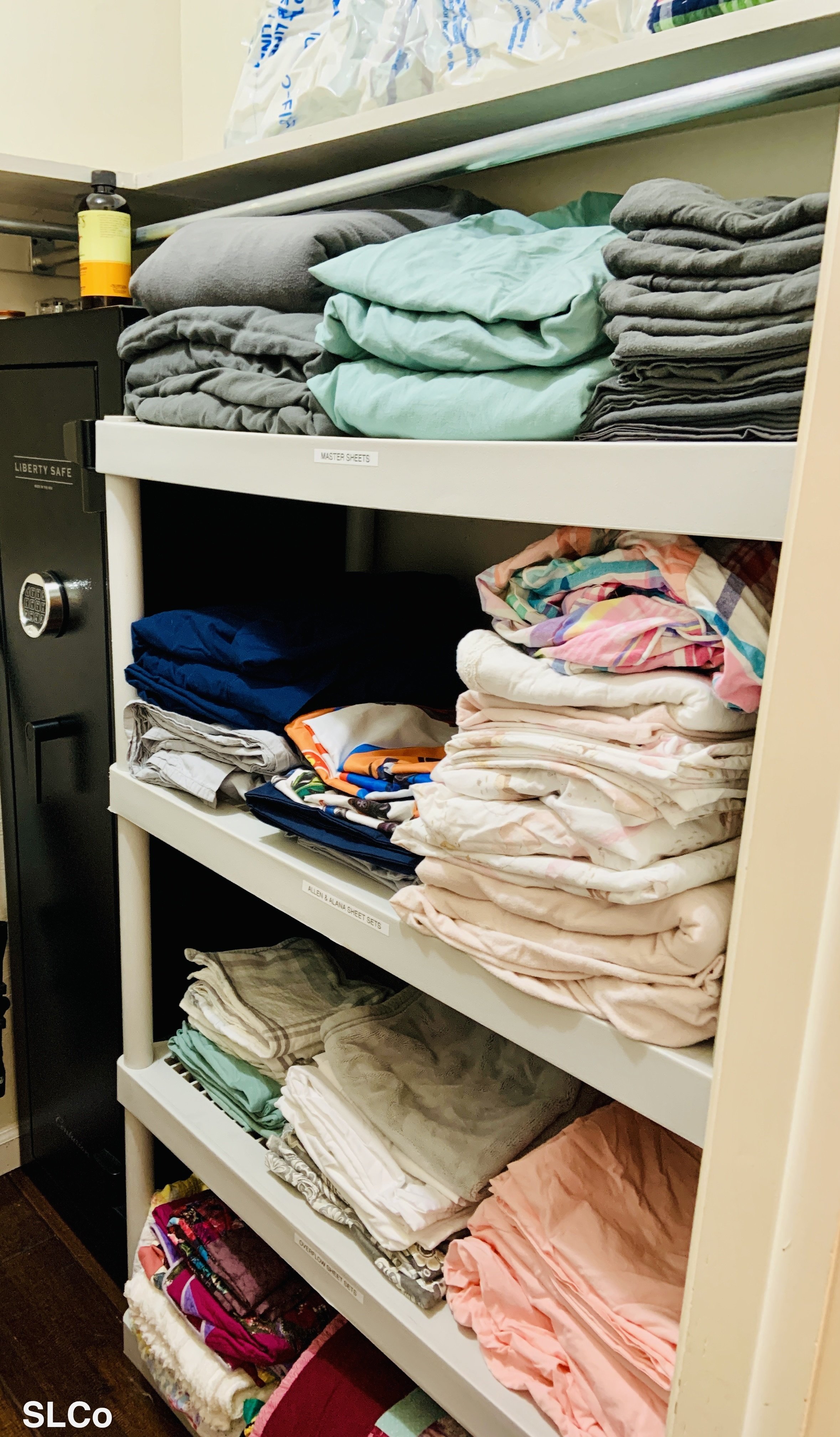 After photo of Arvada storage closet with linens folded on tall white tall shelves
