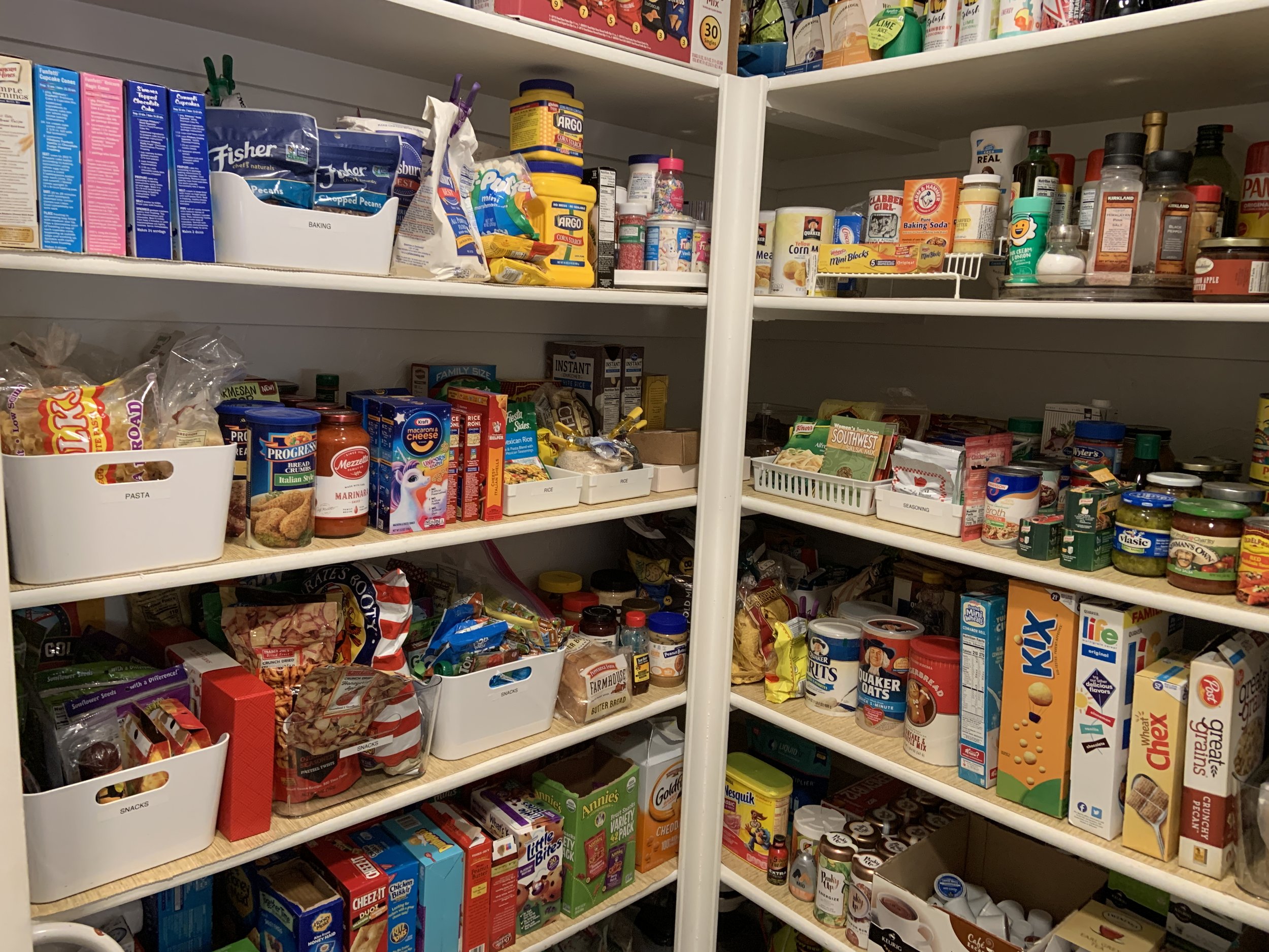 Shelves in large pantry organized where you can see every item in the pantry.