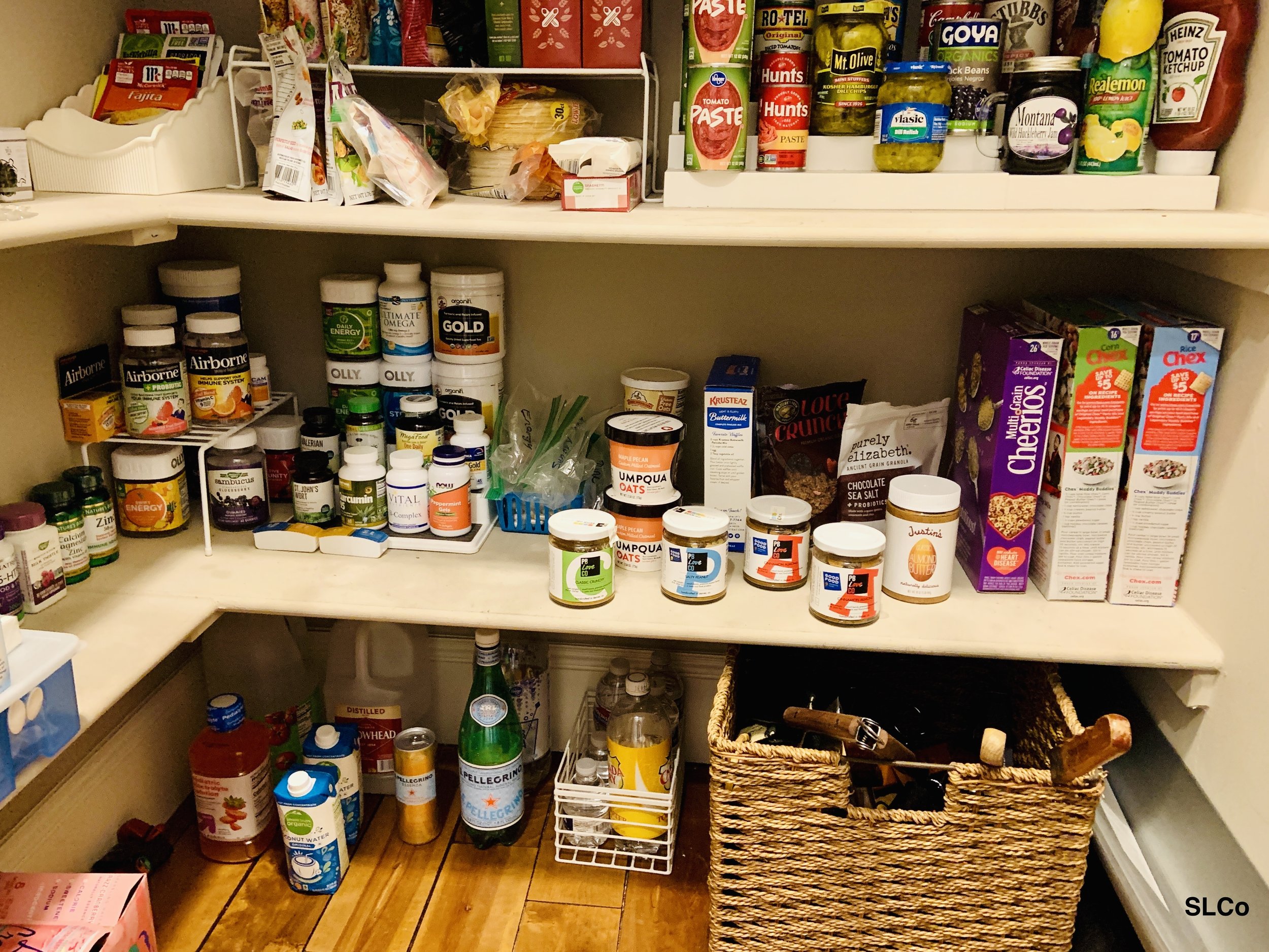 After photo of walk in kitchen pantry with shelves organized and similar kitchen items together.