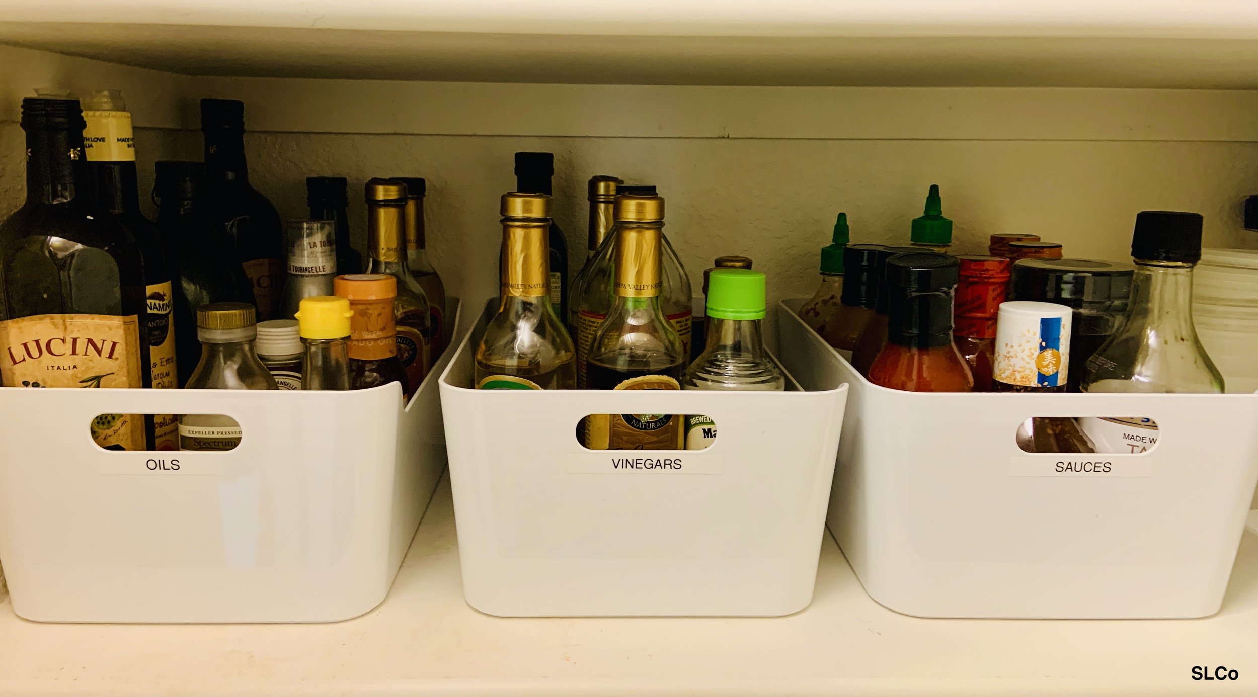 Kitchen shelf with containers labeled for oils