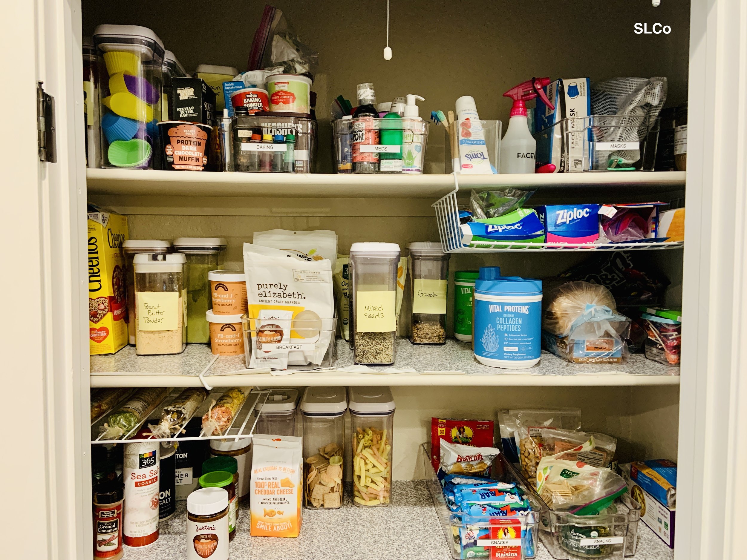 Large pantry with items in containers and organized kitchen items.