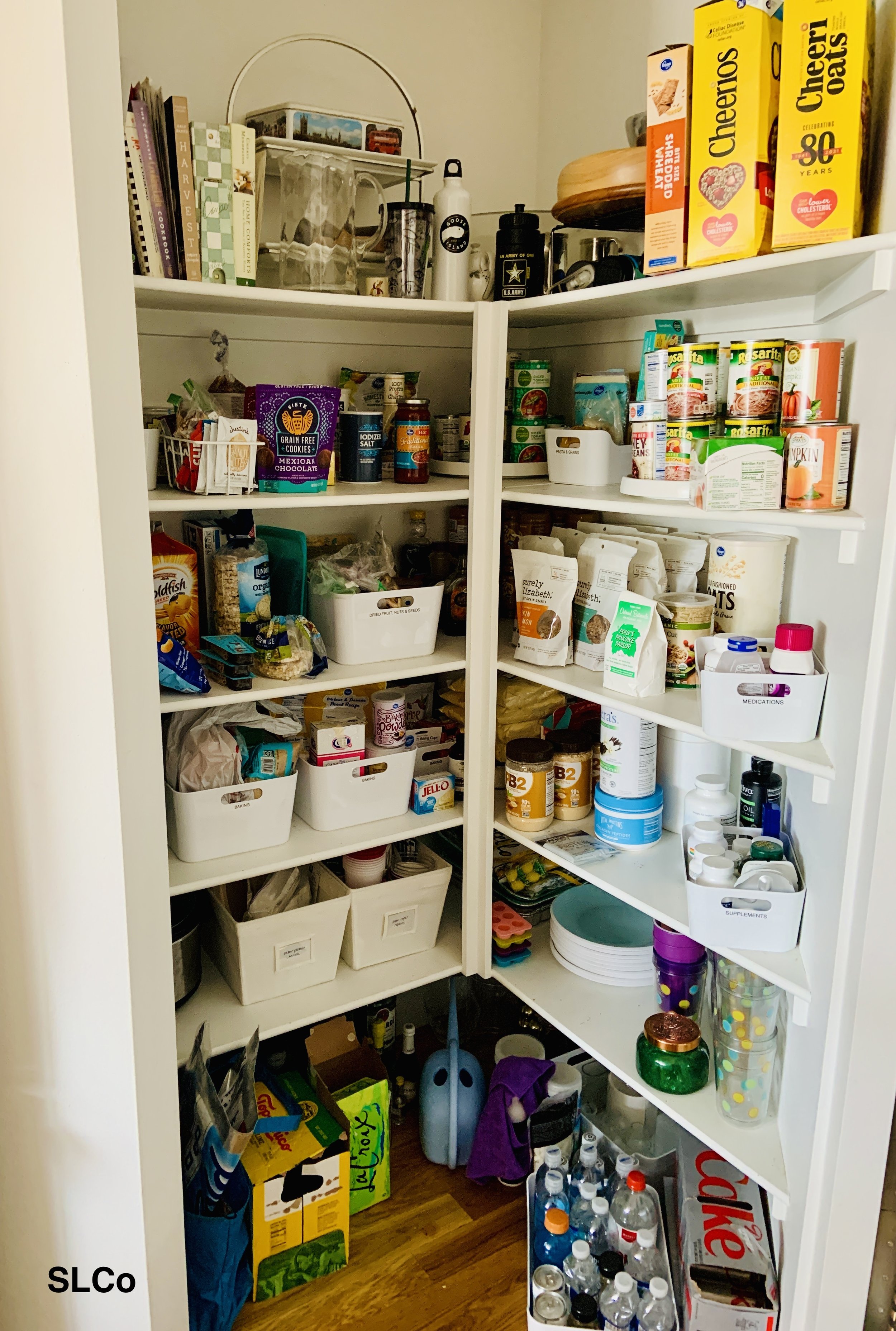 Larger image of kitchen pantry with white containers and items organized together.