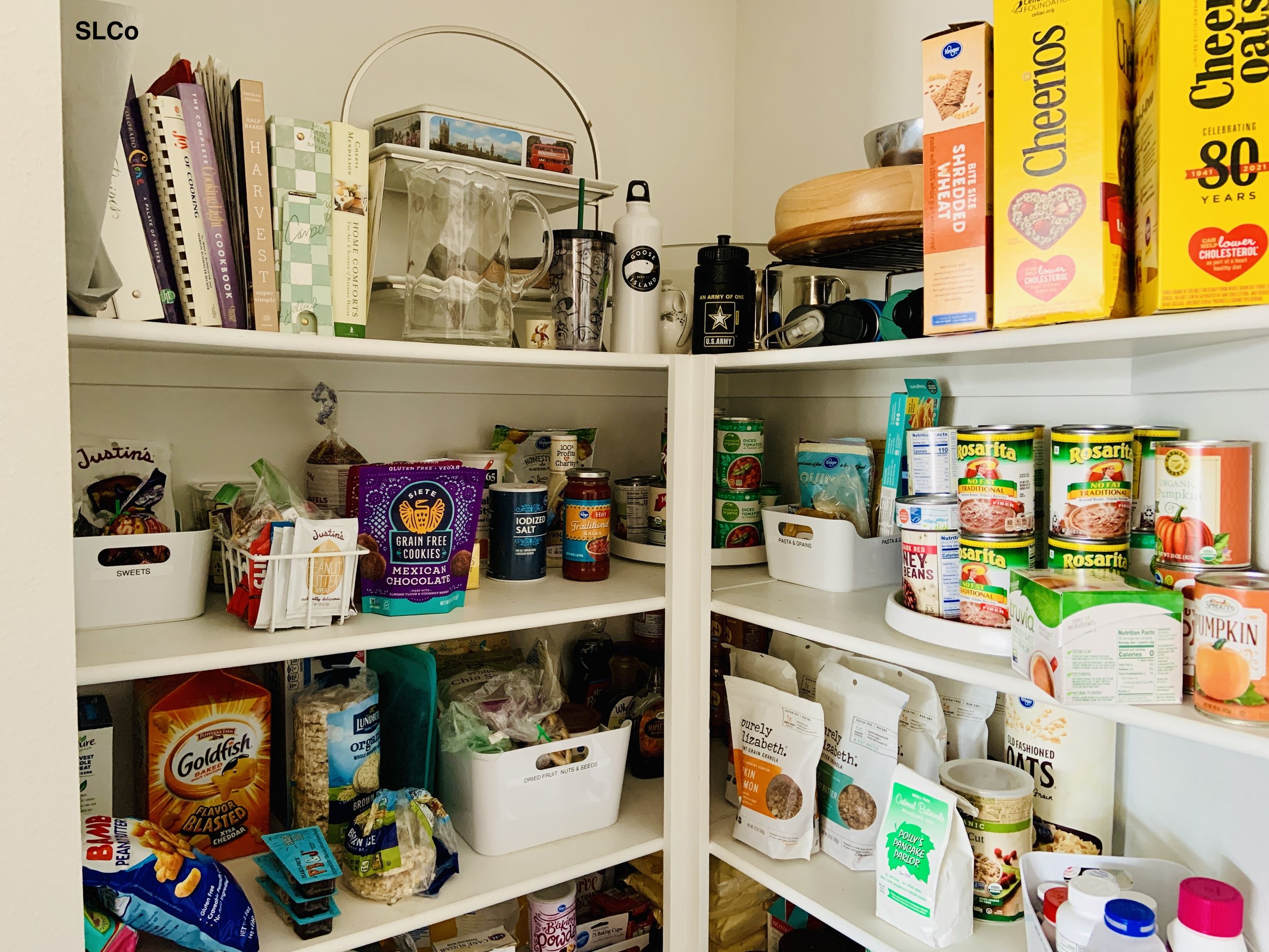 Corner kitchen pantry with white containers and items organized together