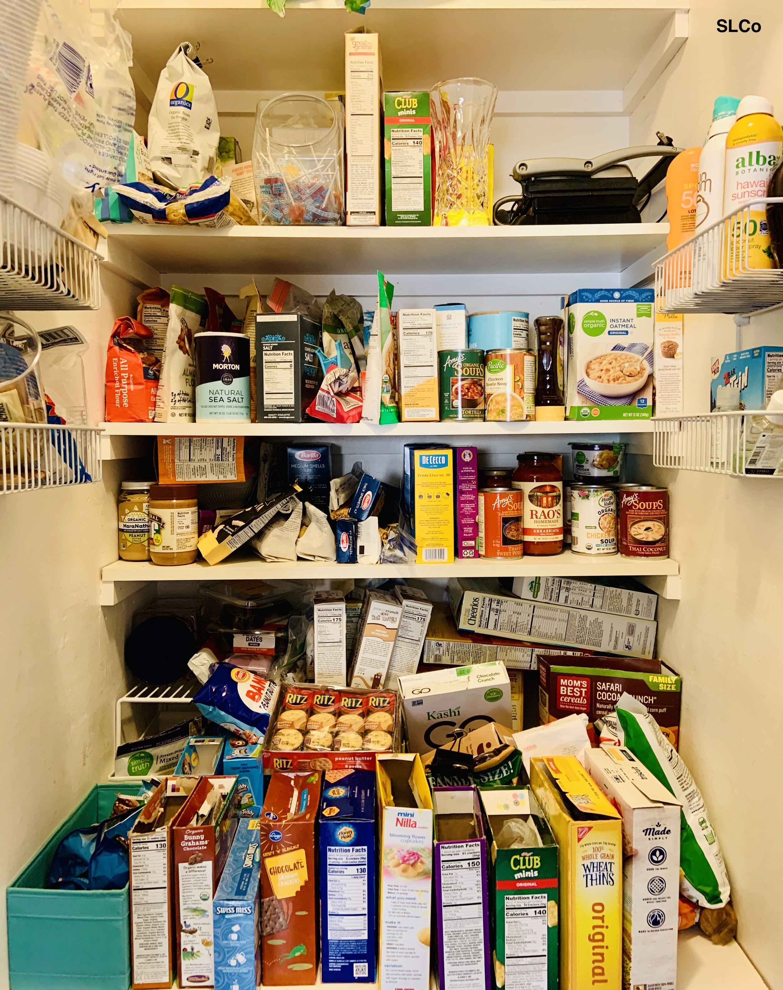 Kitchen pantry with food items on 5 shelves and overflowing