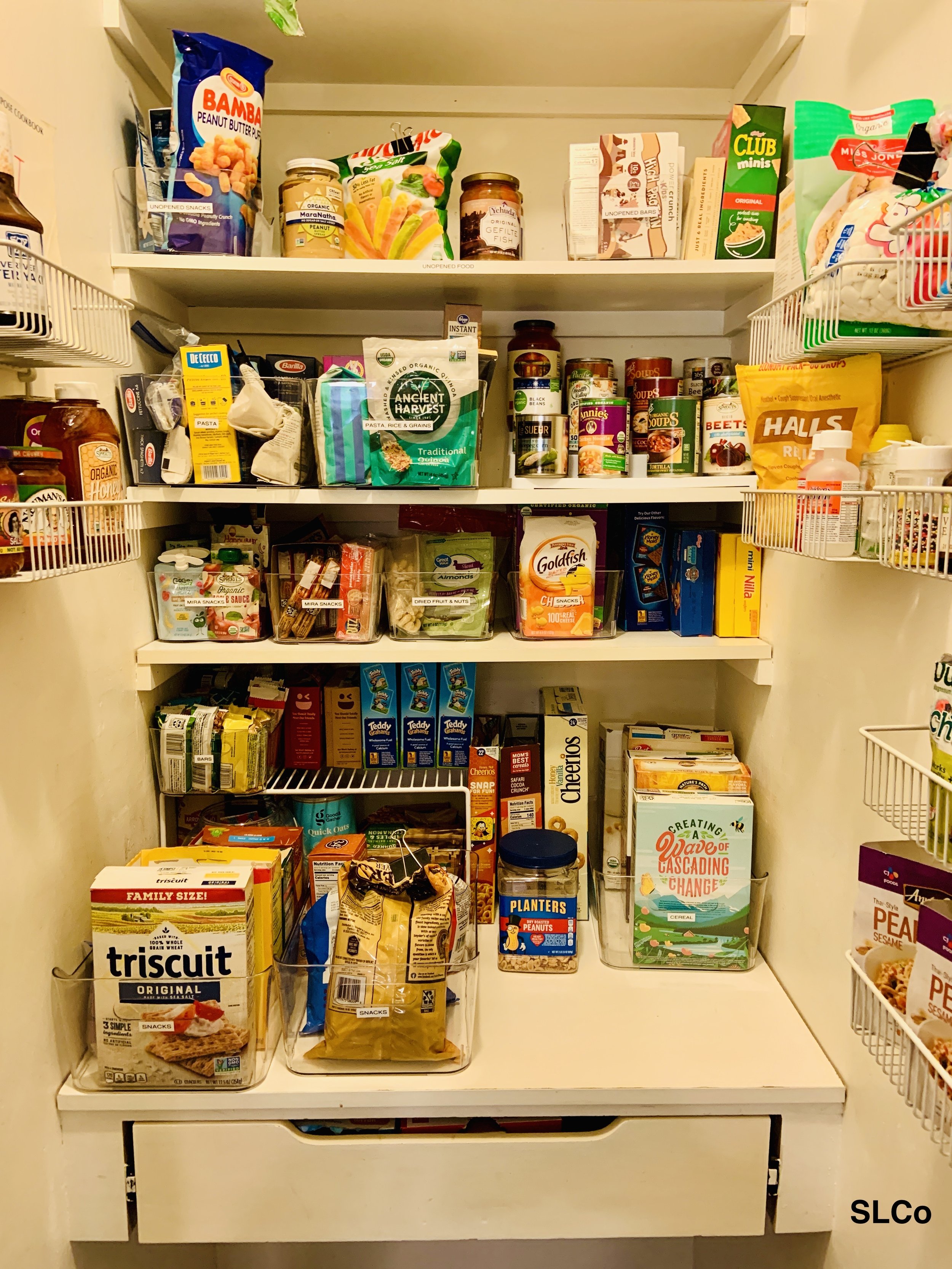 Kitchen pantry with 5 shelves of food items organized by category