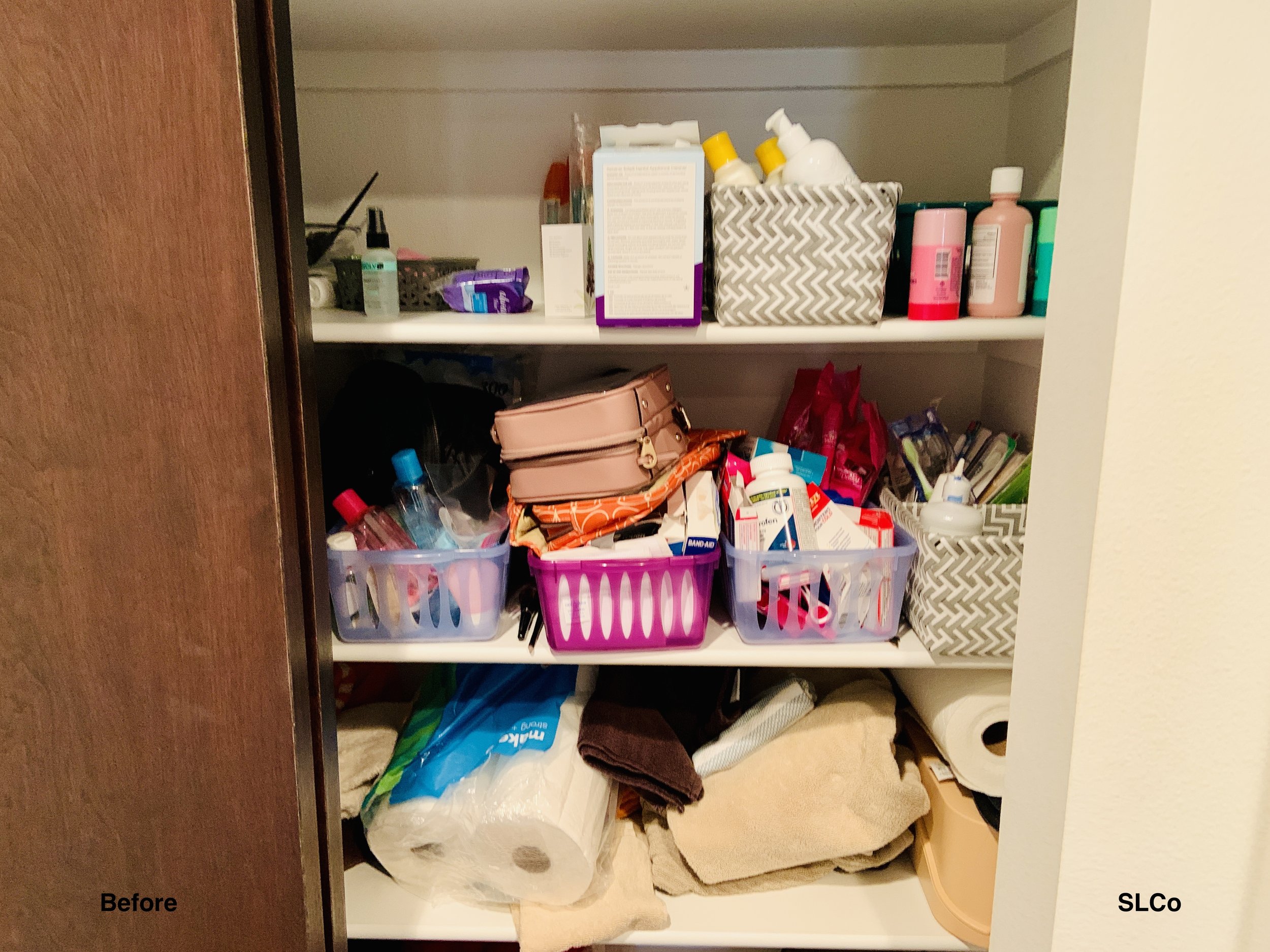 Before image of three shelves in a closet with beauty products unorganized and on top of each other and toilet paper and towels thrown onto bottom shelf.