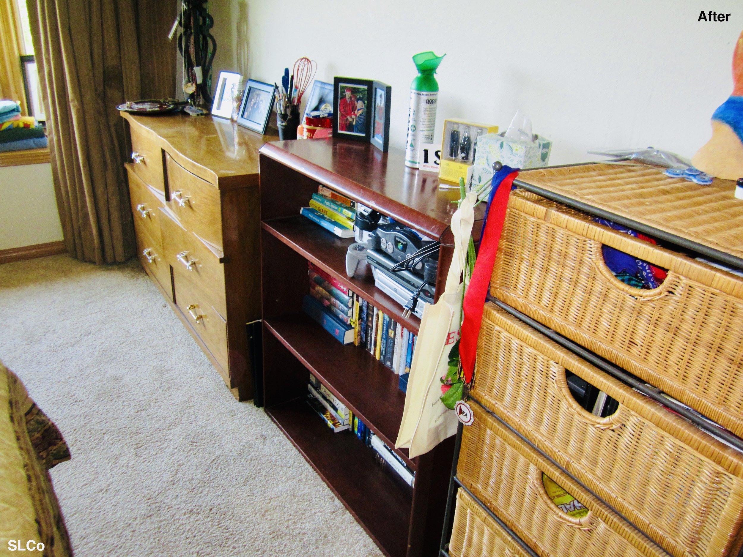 Bedroom with books organized on bookshelf and dresser clean with photos on top