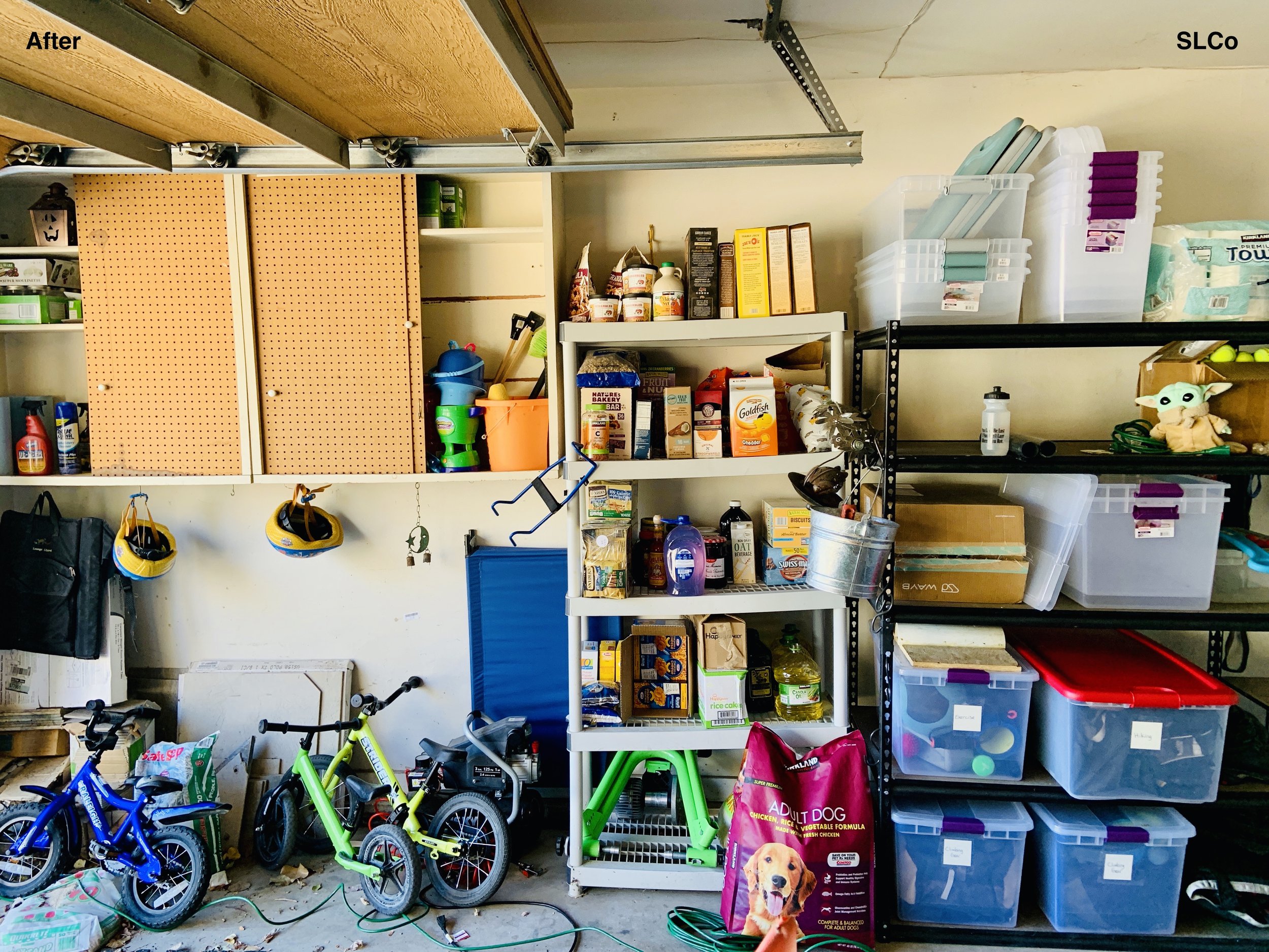 Garage with shelving units on wall with containers with labels and kids bikes against the wall