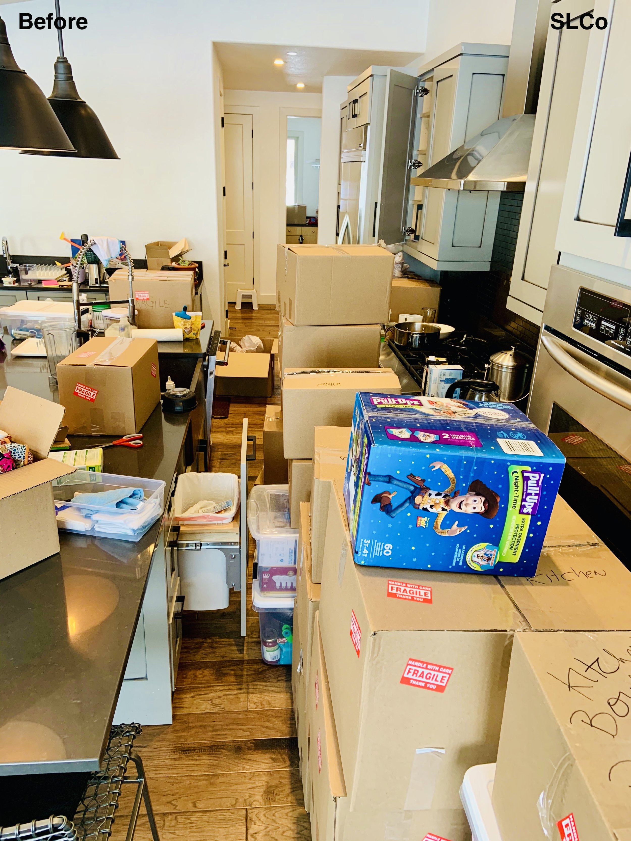 Before photo of kitchen with boxes filling kitchen