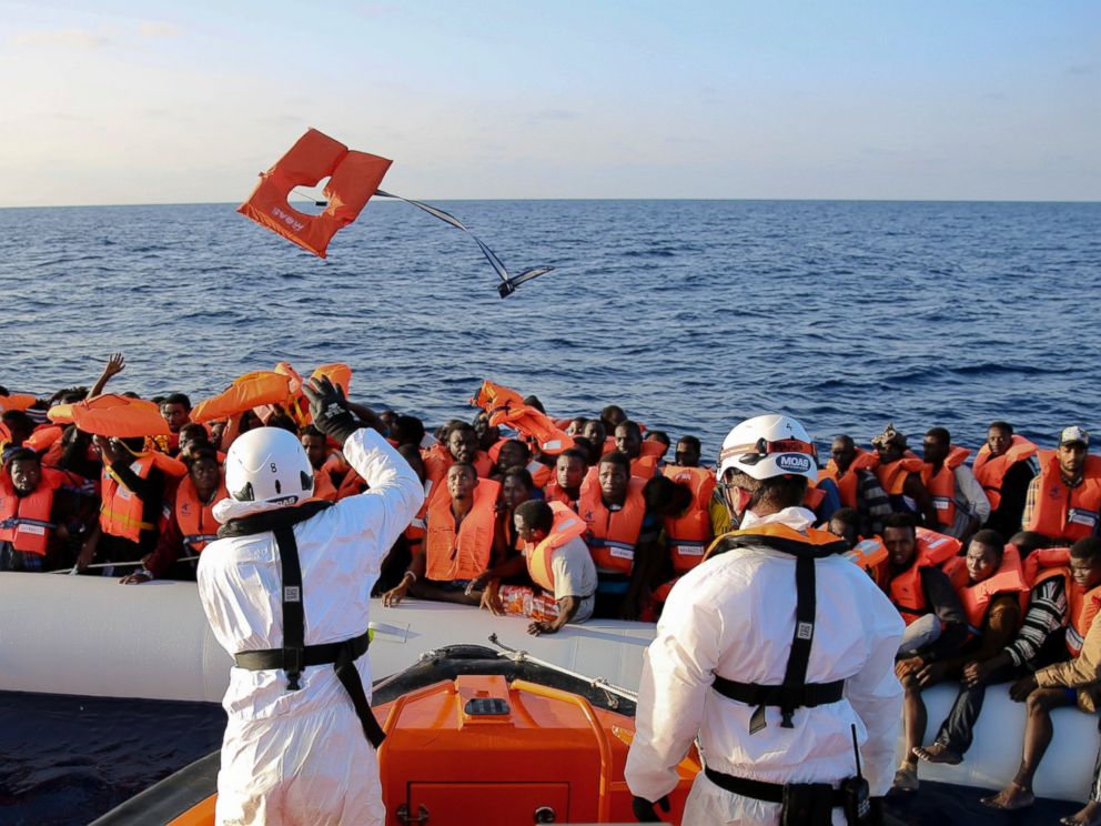 The Italian Red Cross intercepts a migrant vessel off the coast of Libya and proceeds to escort it to Italy. 