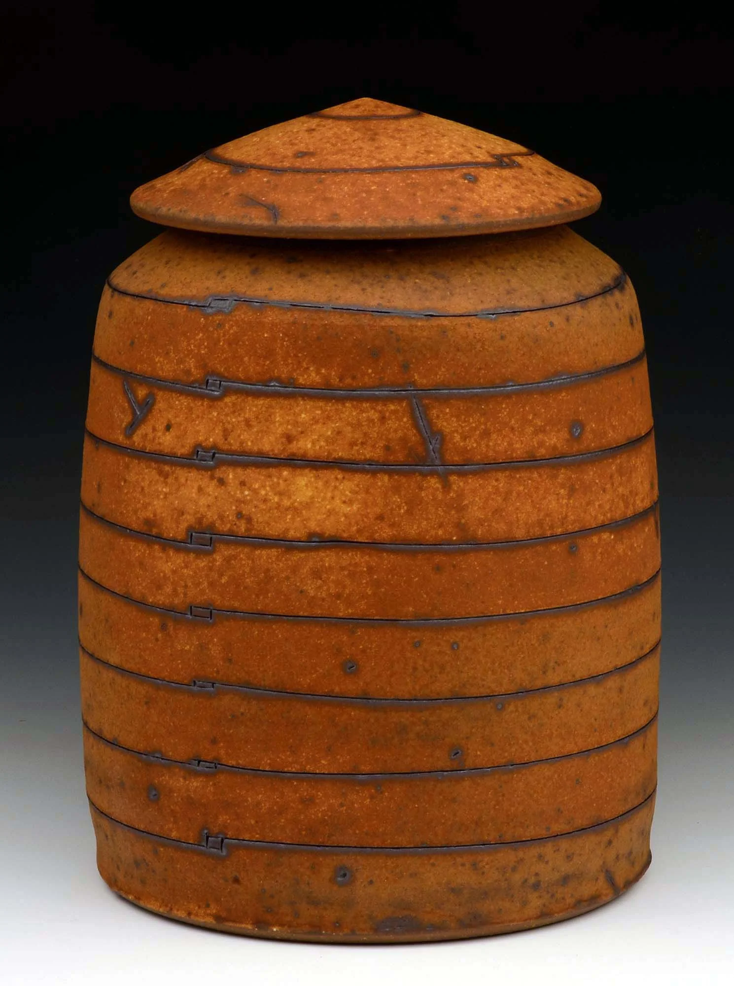 Stoneware, iron stain, clay/ash slip. 9” ht.
