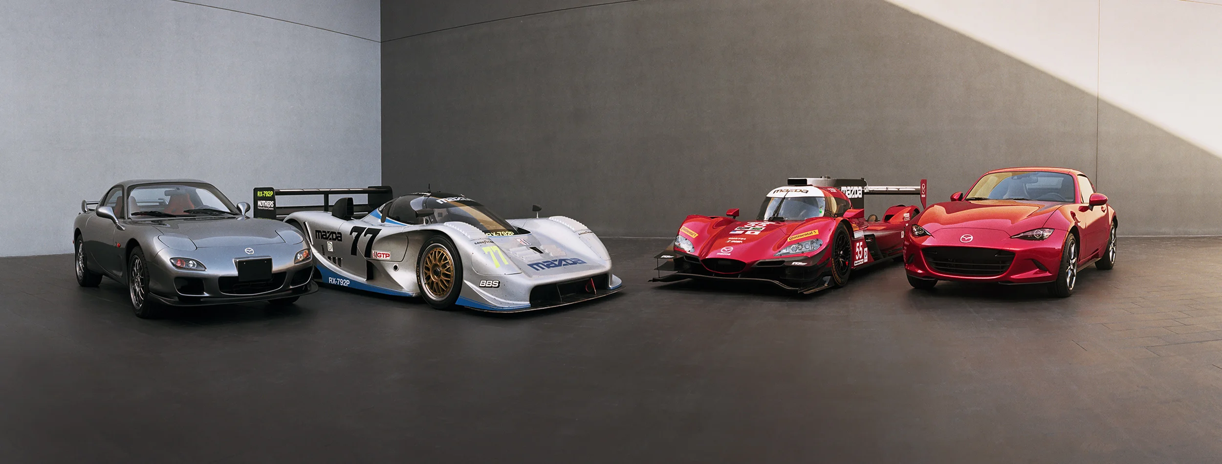 Two racecars, two road cars