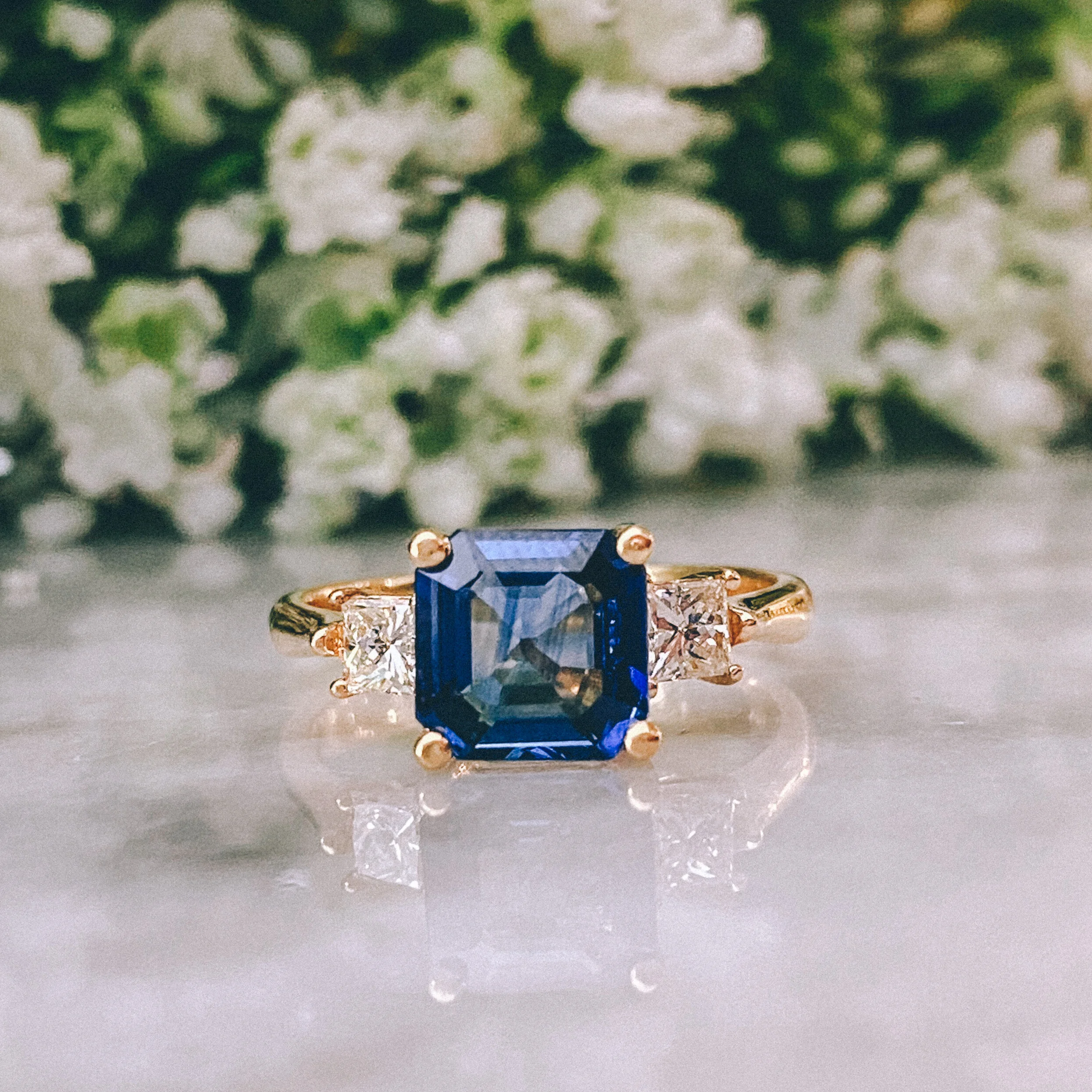18k Yellow Gold 2.28ct Asscher Blue Sapphire Three-Stone Ring with 0.40cttw Princess Cut Diamonds (VVS1-2/G-H)