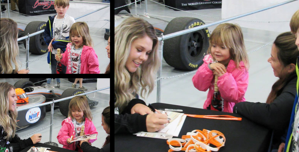 A young fan savors her signed picture from MIanna. 