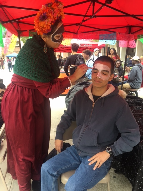  Artist Stephanie Serrano paints a calavera (skull) on dental assistant major, Eduardo Becerril's face during the Día De Los Muertos event on Chaffey's Rancho Cucamonga campus. The calavera face painting is a traditional aspect of the Día De Los Muer