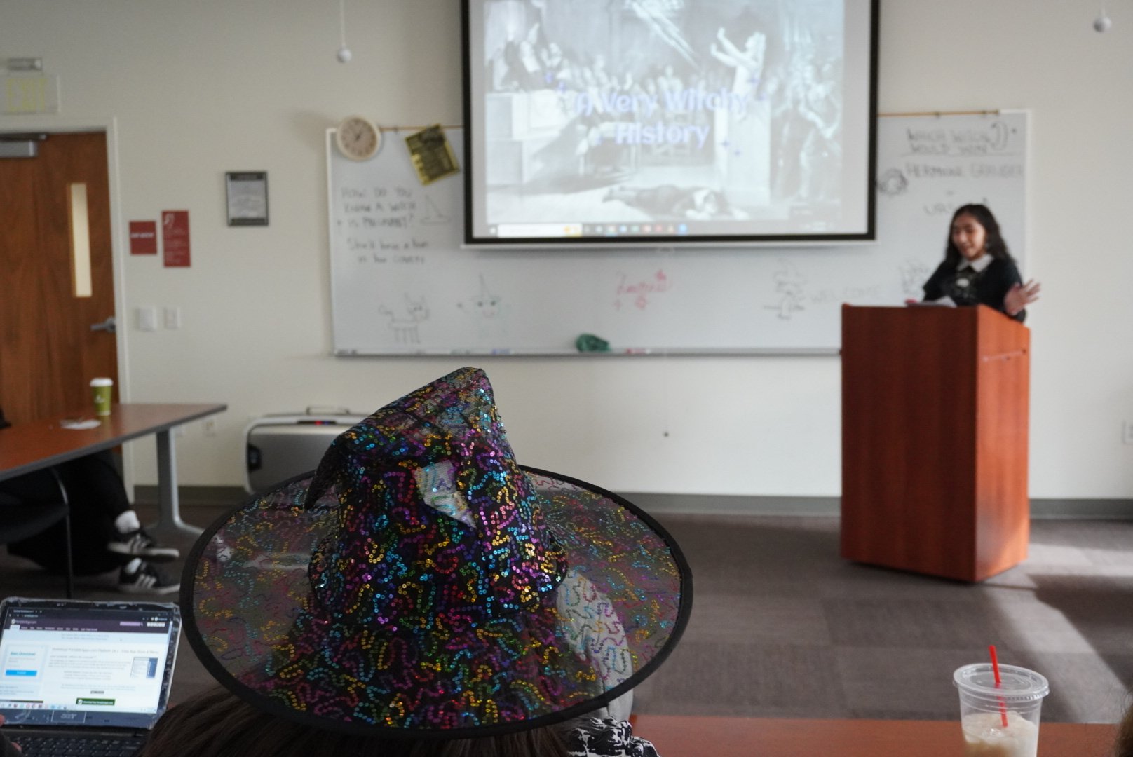  Members watch as Liliana Arredondo introduces herself and begins her presentation / Photo by Elizabeth Muñoz  Between patriarchal protection and witch tropes, the meeting expressed how witchy women appear in both society and entertainment. 