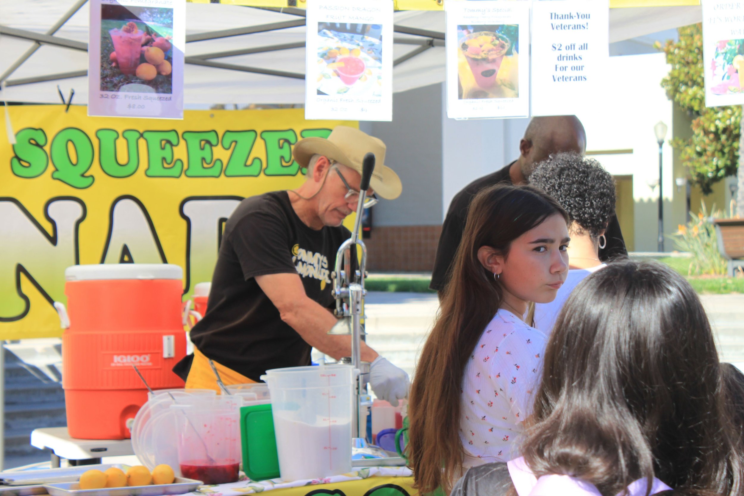  A serpentine line forms, eagerly anticipating the refreshment of freshly made lemonade, as the zesty aroma wafts through the air, creating a buzz of anticipation at the market stand. Photo by Jess Rodrigo 