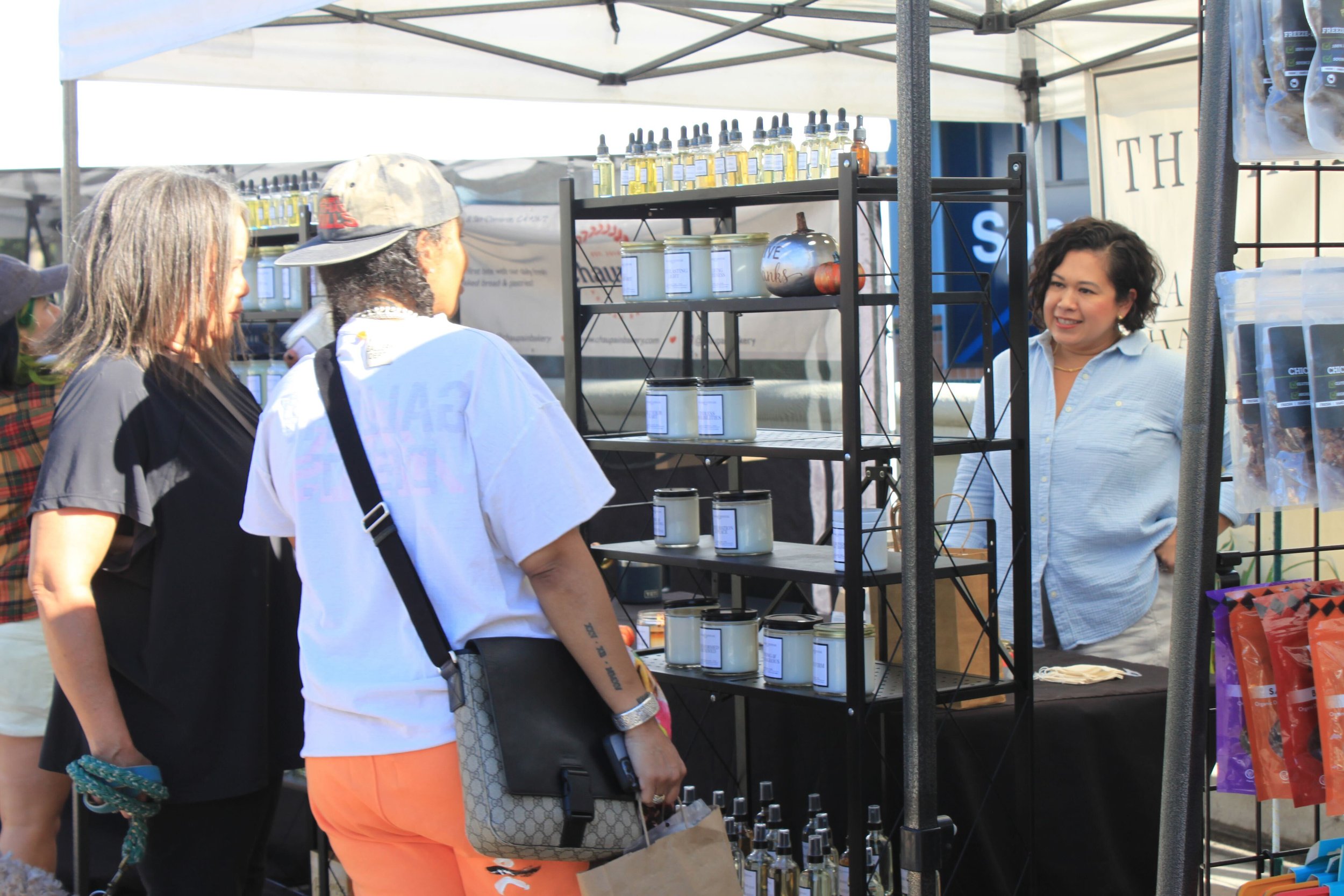  Engaging conversation unfolds as two individuals express genuine interest in the personal care offerings, captivated by the vendor's products and the promise of self-care indulgence. Photo by Jess Rodrigo 