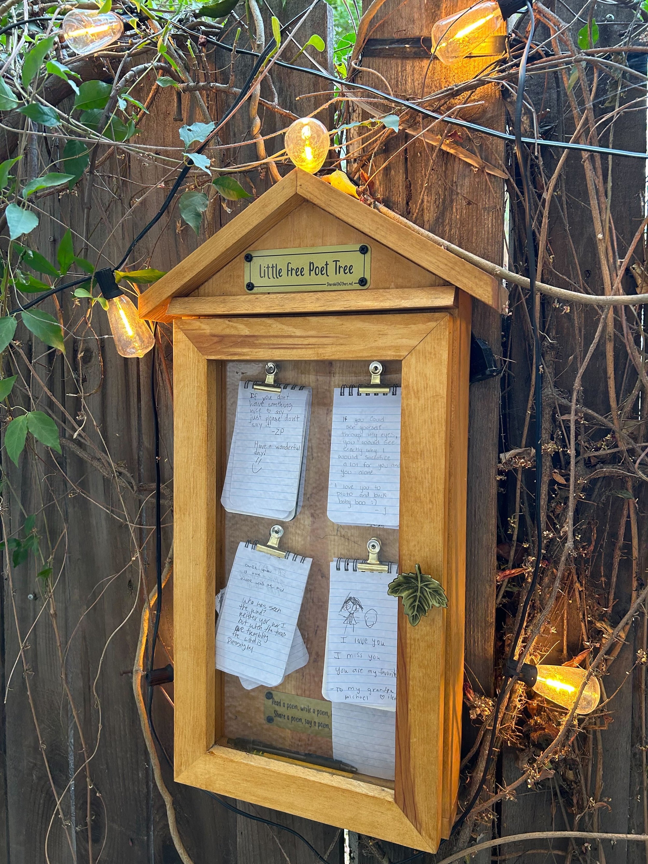 Little display with poems and notes written by visitors of the shop located outside.
