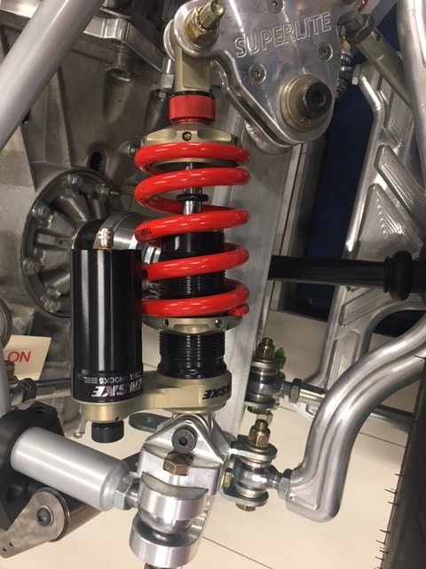 Rear shock. Spring retainer is above the spring and the ride height adjustment collar is below the spring