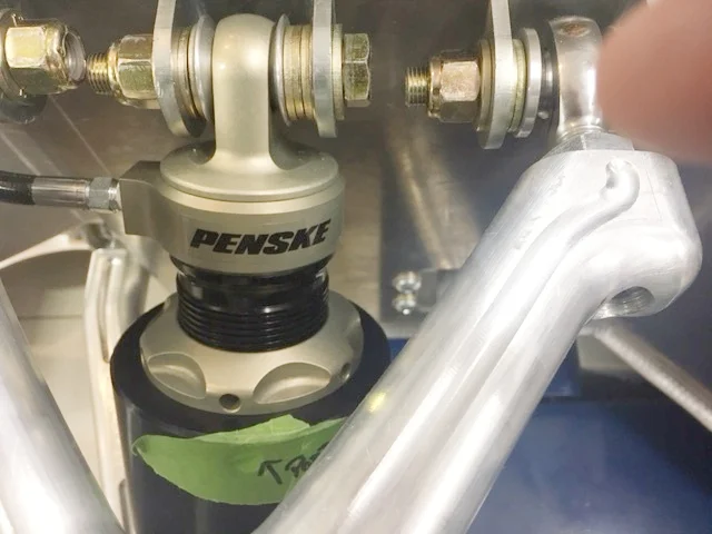 The ride height adjustment collar is the round, gold piece above the green tape