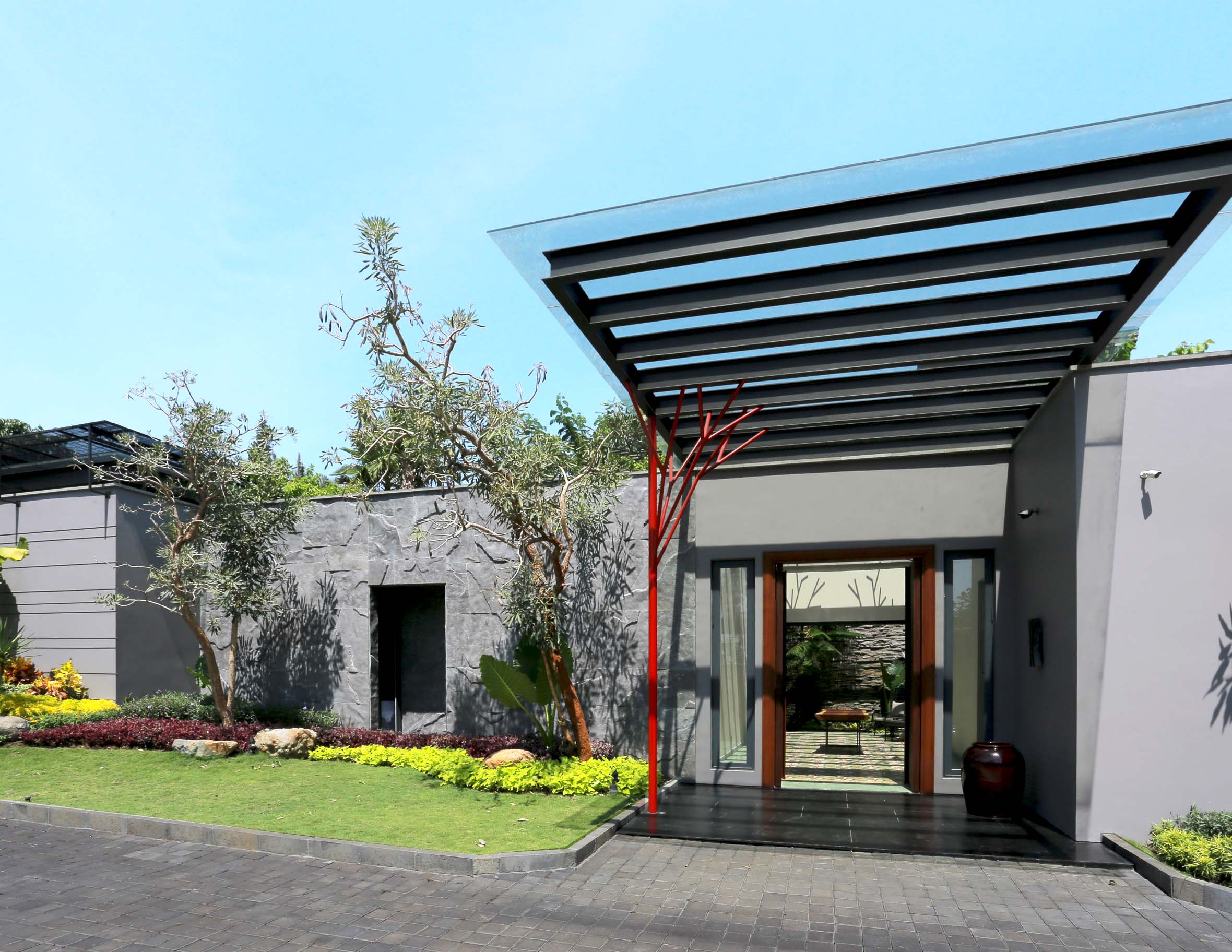 A glass cantilevered roof welcomes visitors into the multi-function area. The natural stone flooring and small gardens on both sides bring a soft tropical touch to the contemporary structure.
Normal
0
false
false
false
IN
X-NONE
X-NONE
/* Style Definitions */
table.MsoNormalTable
{mso-style-name:"Table Normal";
mso-tstyle-rowband-size:0;
mso-tstyle-colband-size:0;
mso-style-noshow:yes;
mso-style-priority:99;
mso-style-qformat:yes;
mso-style-parent:"";
mso-padding-alt:0cm 5.4pt 0cm 5.4pt;
mso-para-margin-top:0cm;
mso-para-margin-right:0cm;
mso-para-margin-bottom:8.0pt;
mso-para-margin-left:0cm;
line-height:107%;
mso-pagination:widow-orphan;
font-size:11.0pt;
font-family:"Calibri","sans-serif";
mso-ascii-font-family:Calibri;
mso-ascii-theme-font:minor-latin;
mso-fareast-font-family:"Times New Roman";
mso-fareast-theme-font:minor-fareast;
mso-hansi-font-family:Calibri;
mso-hansi-theme-font:minor-latin;}