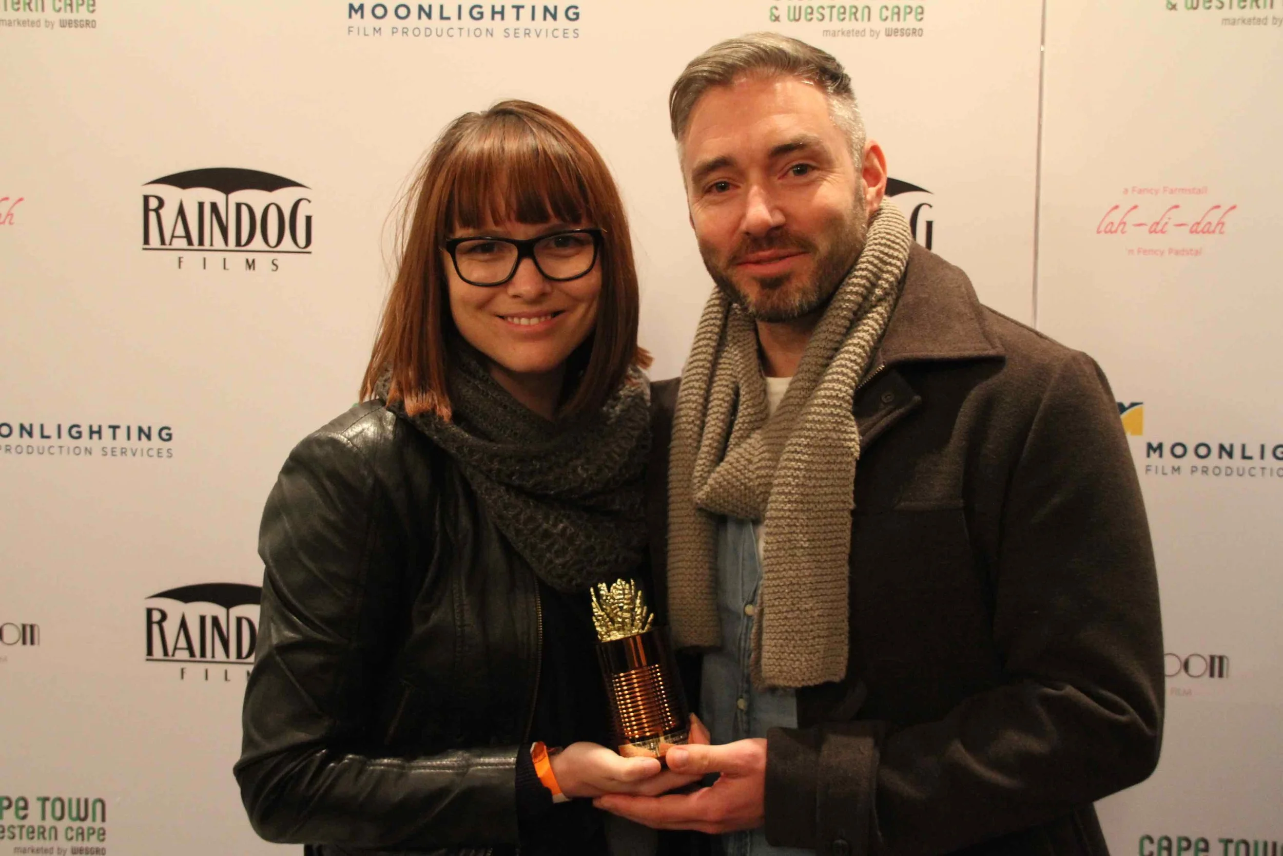 2016 Best Feature Documentary Winners Kelly Scott and Richard Finn Gregory in front of our Sponsor & Supporter Photo Wall