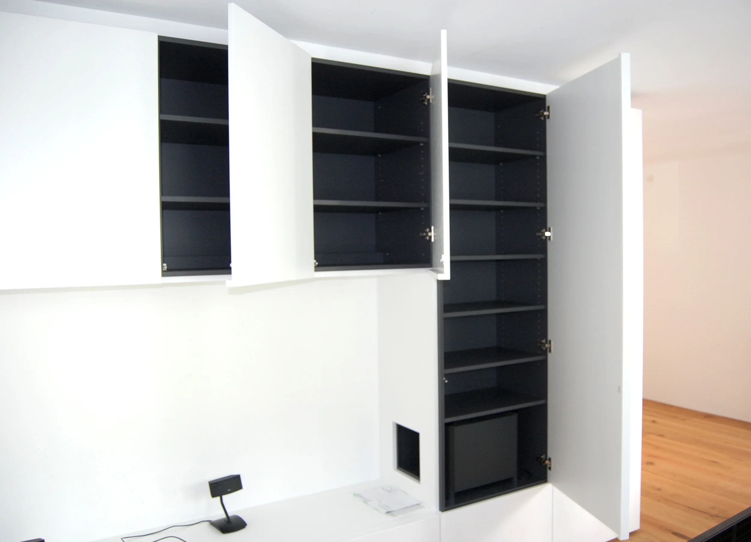 Dark matt grey interior gives these cabinets a chic feel.