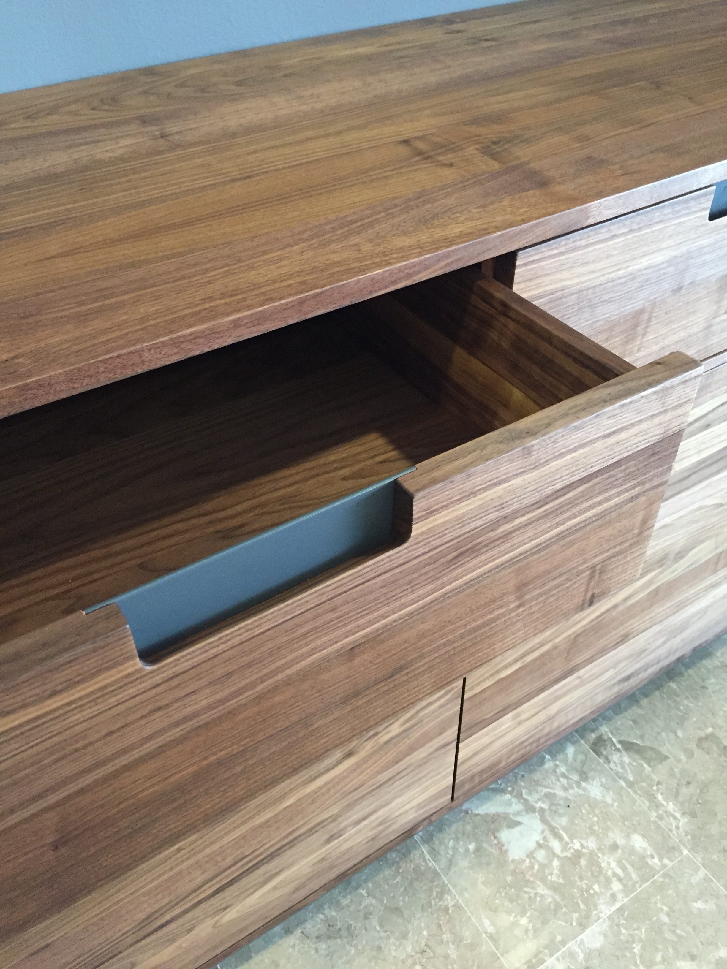 Drawer insert handles in smoked gun powder steel.