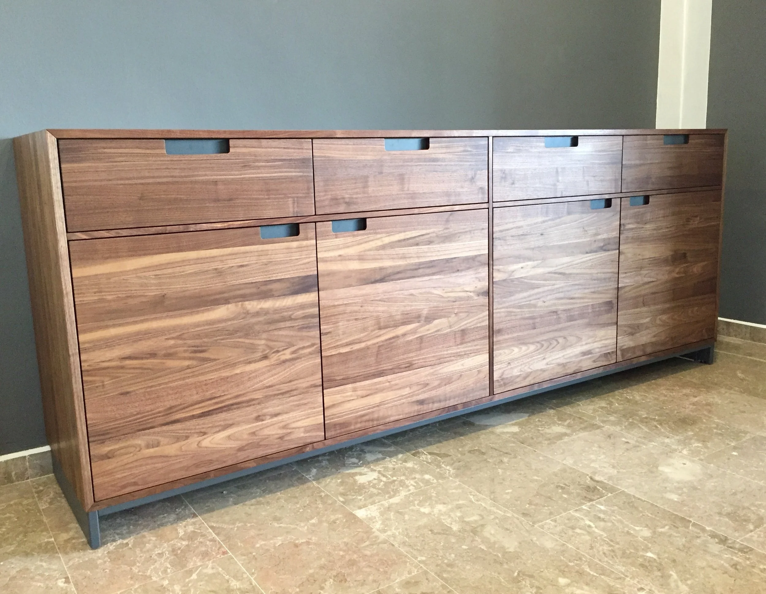 Standing handsome at the entrance of a 1700 sq ft apartment is a 2.35m long, 0.5m deep, with a 0.9m tall piece of solid Walnut Sideboard on powder coated steel legs.