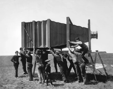 The Hitherto Impossible: The Mammoth In 1900, Chicago and Alton Railroad wanted to take a large panoramic photo of an entire train. George Lawrence, whose company's tagline read "The Hitherto Impossible in Photography Is Our Specialty," came forward. He designed and built the "Mammoth," a massive camera that weighed 1,400 pounds (635 kg) and required fifteen operators! The resulting 8.5ft x 4.5ft (2.6m x 1.4m) picture, though initially called a fake by critics, was later awarded "Grand Prize of the World for Photographic Excellence".