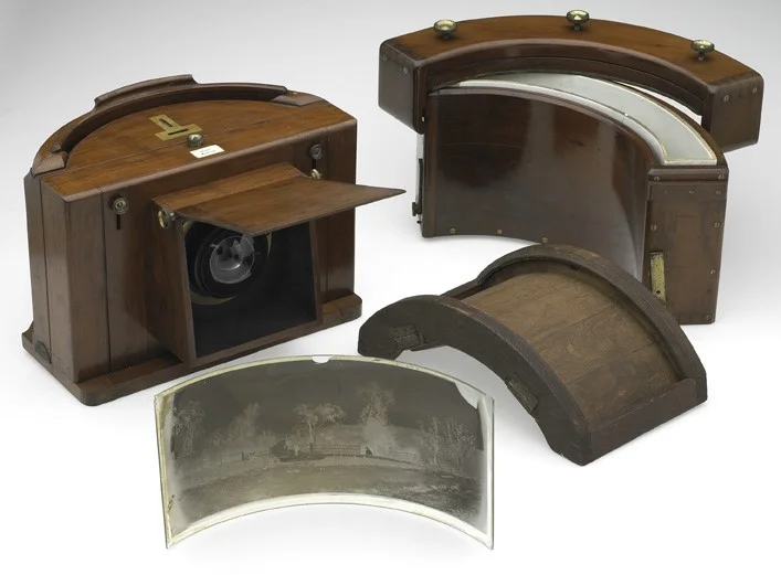 Panoramic camera, designed in England by Thomas Sutton c1861 , and one of about 30 produced. The camera lens is made up of two hollow glass hemispheres. The flap on the front of the camera lifts up to allow an image to be taken. Credits: Reproduced courtesy of Museum Victoria Creator: Thomas Sutton, designer, c1861 Jon Augier, photographer Identifiers: Museum Victoria image number MN 14973 Museum Victoria object registration number ST 029632 TLF resource R6388 Source: Museum Victoria, http://www.museum.vic.gov.au/
