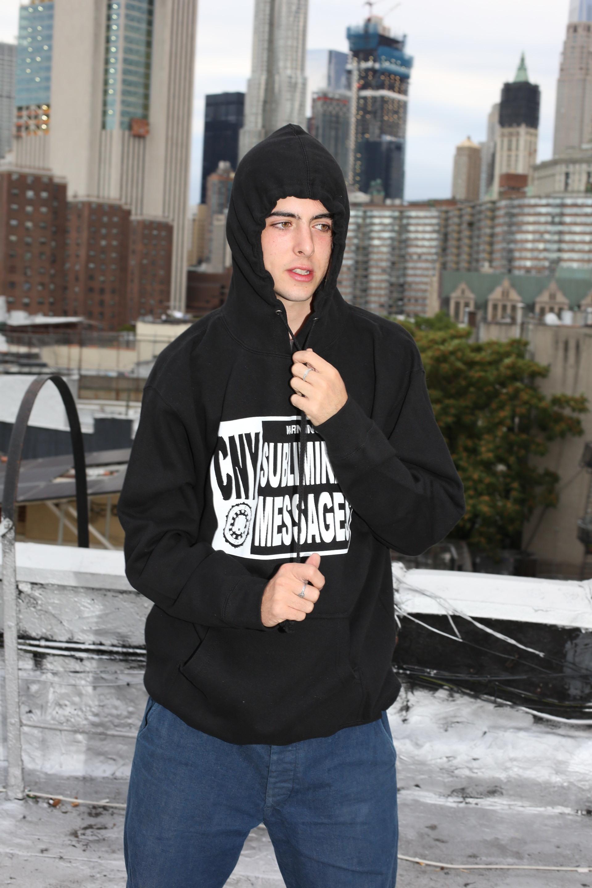 tucker wearing black subliminal hoodie in large