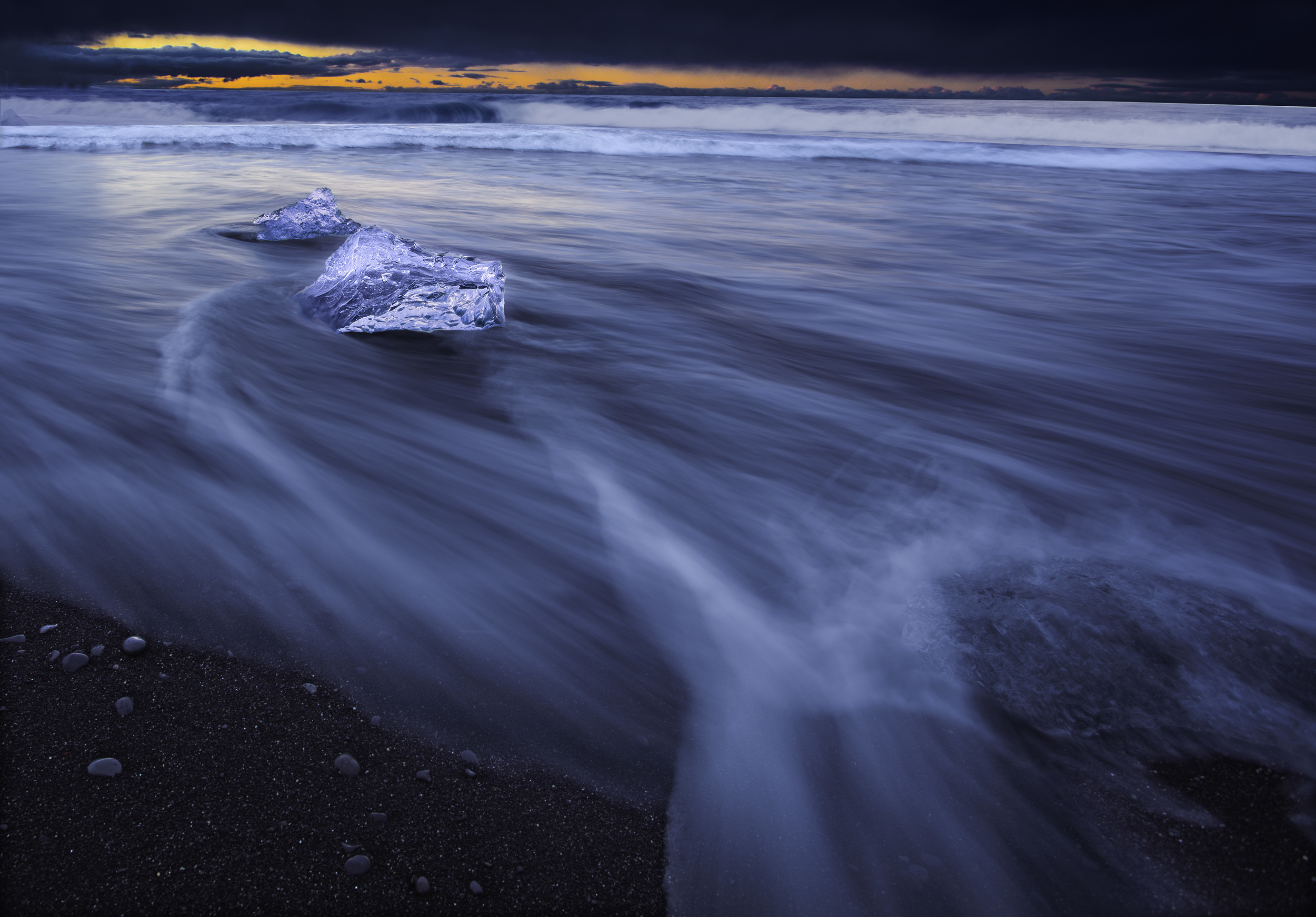   ICELAND.&nbsp;  JOKULSARION ICE BEACH. &nbsp; THE ICE LOOKS LIKE IT IS FLOATING IN THE AIR BECAUSE THE WAVE WAS WASHING AWAY THE SAND BENEATH IT AS I WAS TAKING THE PHOTO. 