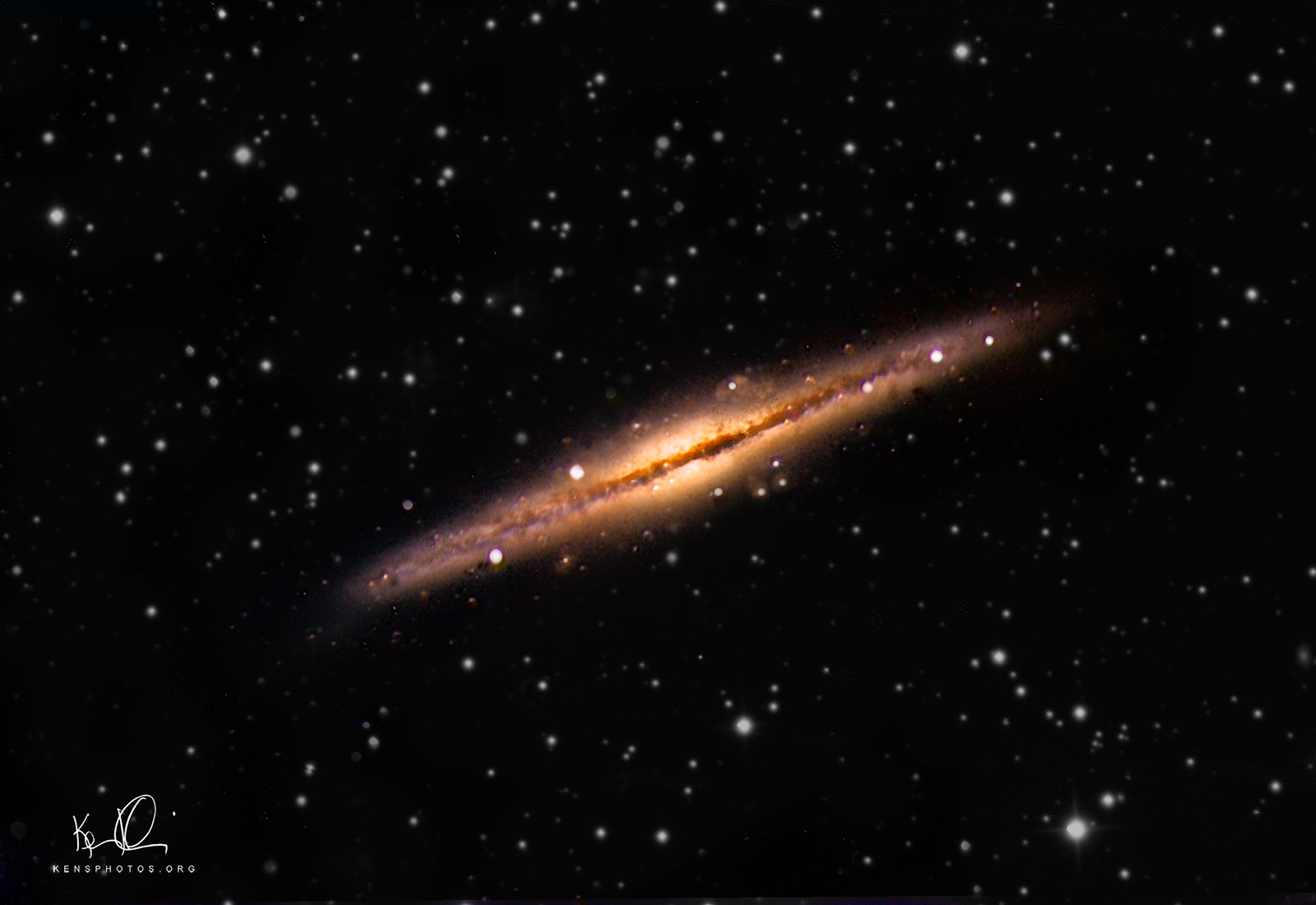   NGC 891. &nbsp; THIS IS A PHOTO OF AN EDGE-ON GALAXY WHICH APPEARS AS A THIN DISK. &nbsp;VERY DIFFERENT THAN M51 OR M31 WHERE YOU SEE THE GALAXY AT AN ANGLE. 